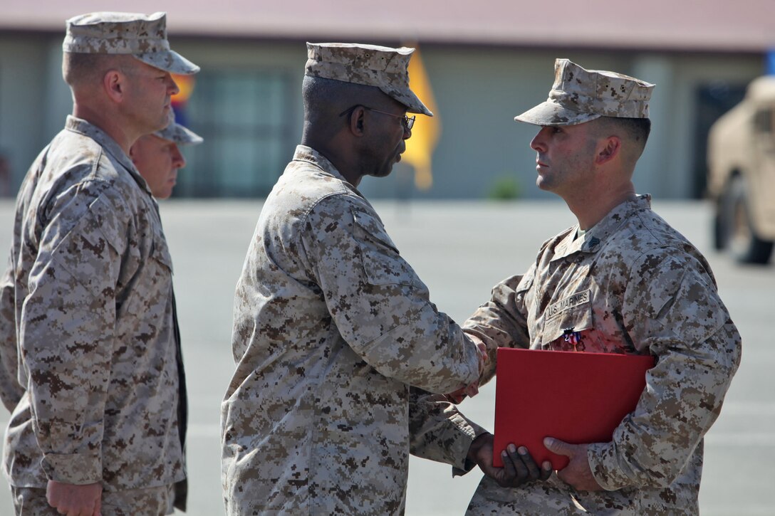 Sgt. Ryan T. Sotelo, Battalion Landing Team 3/5, 15th Marine Expeditionary Unit, shakes hands with Maj. Gen. Ronald L. Bailey, commanding general, 1st Marine Division, after receiving the Silver Star at San Mateo, Calif., March 30. Sotelo received the United States’ third highest award for combat valor for actions he took as a squad leader with Kilo Company, 3rd Battalion, 5th Marine Regiment while deployed to Sangin District, Afghanistan.