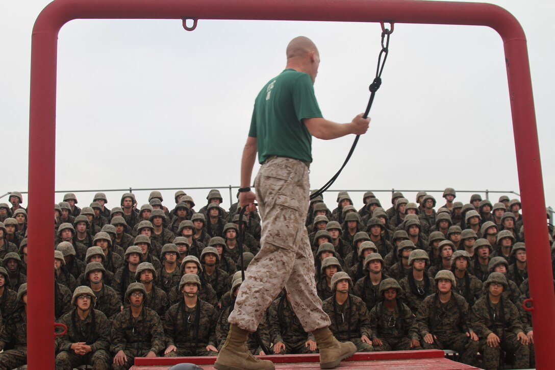 Sgt. Christopher Battaglia ,Static Rope Training Specialist, Martial Arts Satellite School, Recruit Training Regiment, demonstrates the proper techniques to rappel March 30 aboard Marine Corps Recruit Depot San Diego. Company C was given a series of instructions on rappeling and shown examples on the actual tower.
