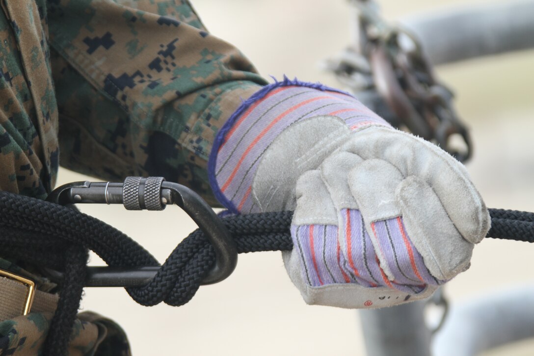 Recruits apply what they were taught to guide with their weak hand, break with their strong hand and keep their knees locked out March 30 aboard Marine Corps Recruit Depot before rappeling.