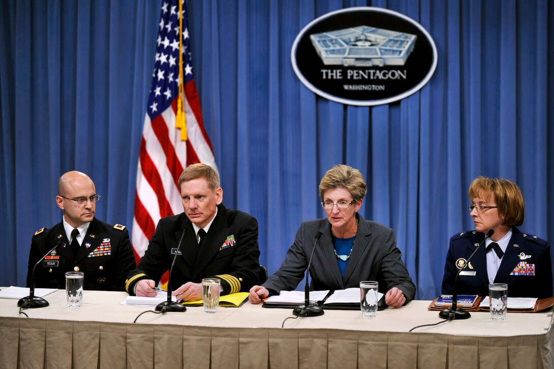 Jo Ann Rooney, acting undersecretary of defense for Personnel and Readiness, second from right, briefs the press on the release of “Appendix E” documents for the Dover Port Mortuary timeline in the Pentagon briefing room, March 30, 2012. Also attending the briefing were Army Col. Richard Teolis Jr., director of the Army’s Casualty and Mortuary Affairs, left; Navy Capt. Craig Mallak, Dover medical examiner; and, far right, Air Force Brig. Gen. Eden J. Murrie, director of Air Force Services. DOD photo by Glenn Fawcett  
