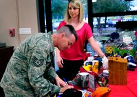 An NCO signs up to win a donated door prize at the grand opening of the newly remodeled Outpost at Duke Field, Fla., recently.   The grand opening featured free food, games, and a live band to showcase the new facility.   The hours of operation are Monday-Friday 11 a.m. to 1 p.m. for lunch, Fridays and UTA Saturdays 3-8 p.m.  (U.S. Air Force photo/Tech. Sgt. Jasmin Taylor)