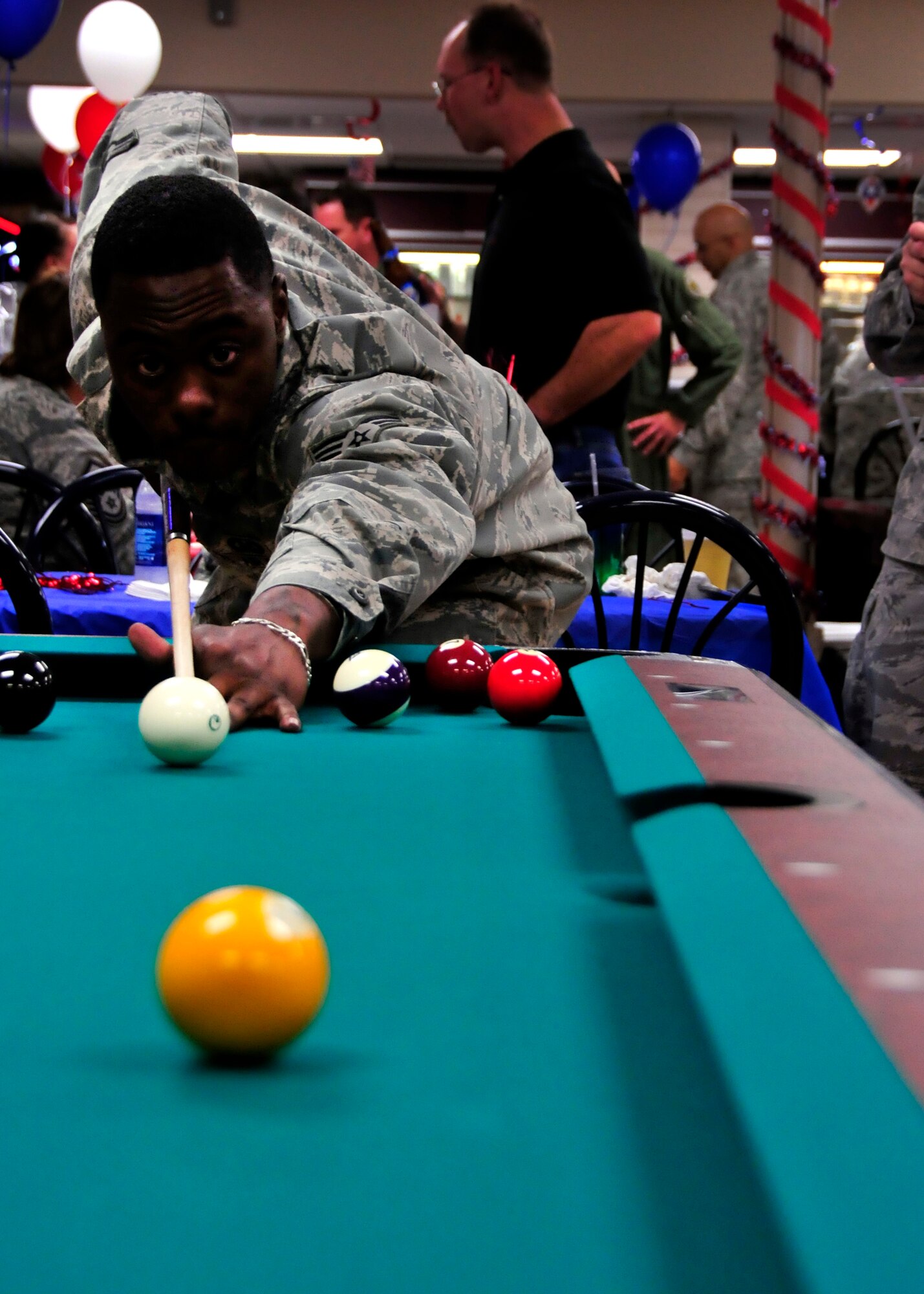 Senior Airman Jamal Anderson, 919th Operations Support Squadron, lines up a shot on the new pool table at the remodeled Outpost on Duke Field, Fla., recently. The grand opening featured free food, games and a live band to showcase the new facility.  The other new games include darts, dollar bingo, a table top quiz game and an X-Box 360 with a Kinect device. (U.S. Air Force photo/Tech. Sgt. Cheryl Foster)