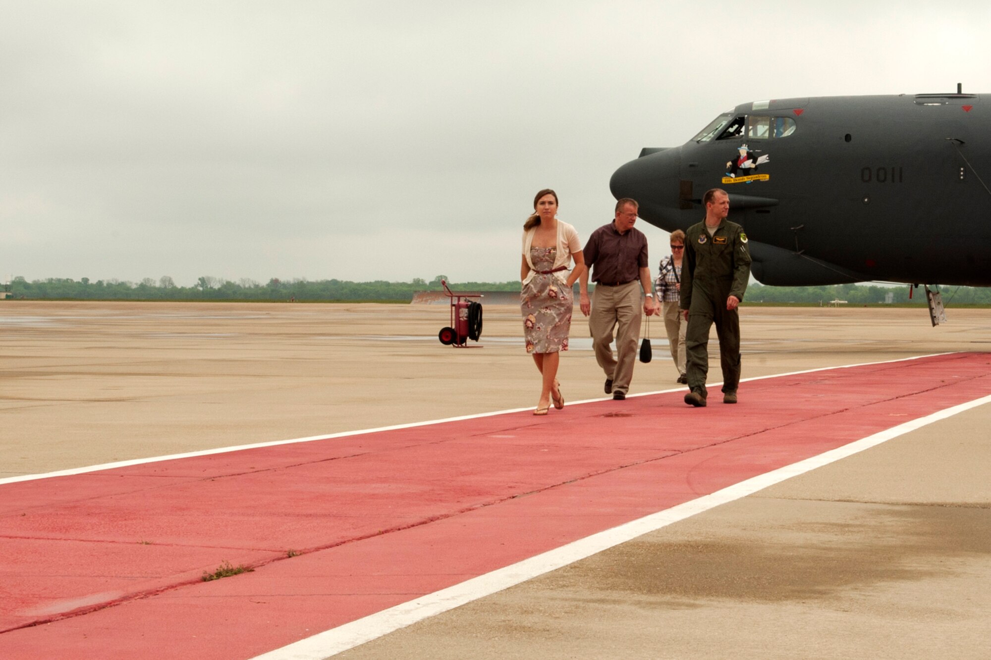 U.S. Air Force 1st Lt. Derek Smith and his family walk the red carpet after getting up close to a 93rd Bomb Squadron B-52 on Barksdale Air Force Base, La., March 30, 2012. Smith is a student of class 11-03 of the B-52 Formal Training Unit at Barksdale and following his class's graduation, he was able to show his family the jet he spent 9 months learning to fly. (U.S. Air Force photo by Master Sgt. Greg Steele/Released)