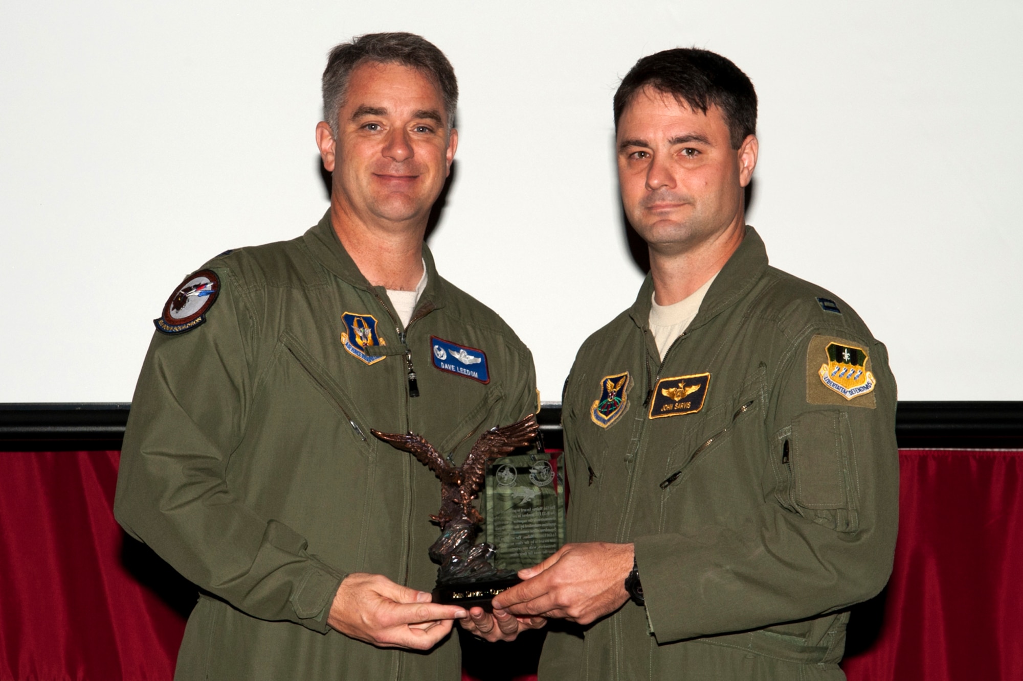 U.S. Air Force Lt. Col. Dave Leedom, 93rd Bomb Squadron commander, presents the Lindell Mabus Leadership Award to Capt. John Sarvis during a Formal Training Unit Class 11-03 graduation ceremony on Barksdale Air Force Base, La., March 30, 2012. Sarvis, a member of class 11-03, received this award which identifies him as the student with exceptional leadership that was critical to the class's graduation. (U.S. Air Force photo by Master Sgt. Greg Steele/Released)