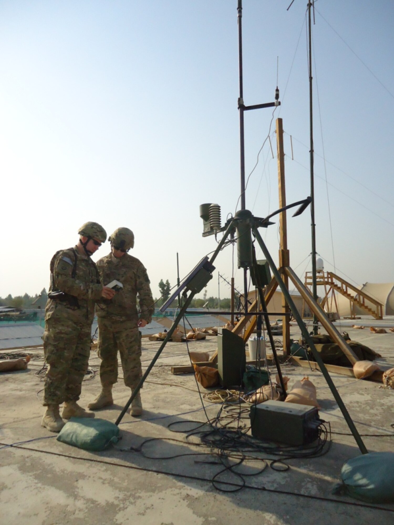 Tech. Sgt. Randy Jones (left) and Staff Sgt. Steven Strength read observation data from a tactical meteorological observing system at Bagram Airfield, Afghanistan.  Jones and Strength are battlefield weather Airmen of the 19th Expeditionary Weather Squadron.  (U.S. Air Force photo/Lt. Col. Gerald Sullivan)