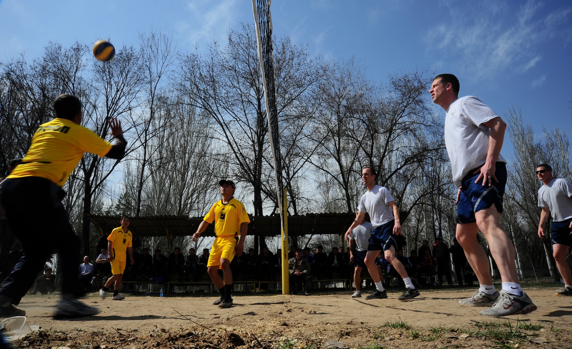 Manas International Airport members and Transit Center at Manas Airmen play a friendly game of volleyball March 30, 2012, during a sports day challenge to celebrate Nowruz, the "Persian New Year" in Manas, Kyrgyzstan. The event included soccer, volleyball and tug of war. (U.S. Air Force photo/Staff Sgt. Angela Ruiz)