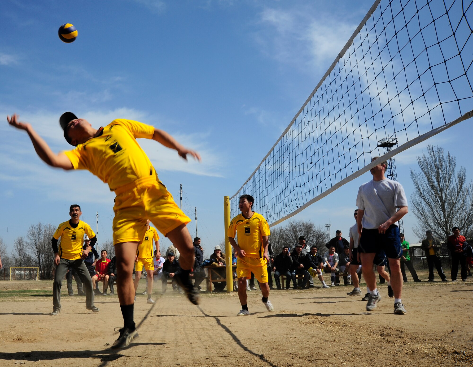 A member of the Manas International Airport Volleyball team prepares to spike the ball March 30, 2012, during a sports day challenge to Nowruz, the "Persian New Year" in Manas, Kyrgyzstan. The Transit Center at Manas Airmen participated in the event, competing in soccer, volleyball and tug of war. (U.S. Air Force photo/Staff Sgt. Angela Ruiz)