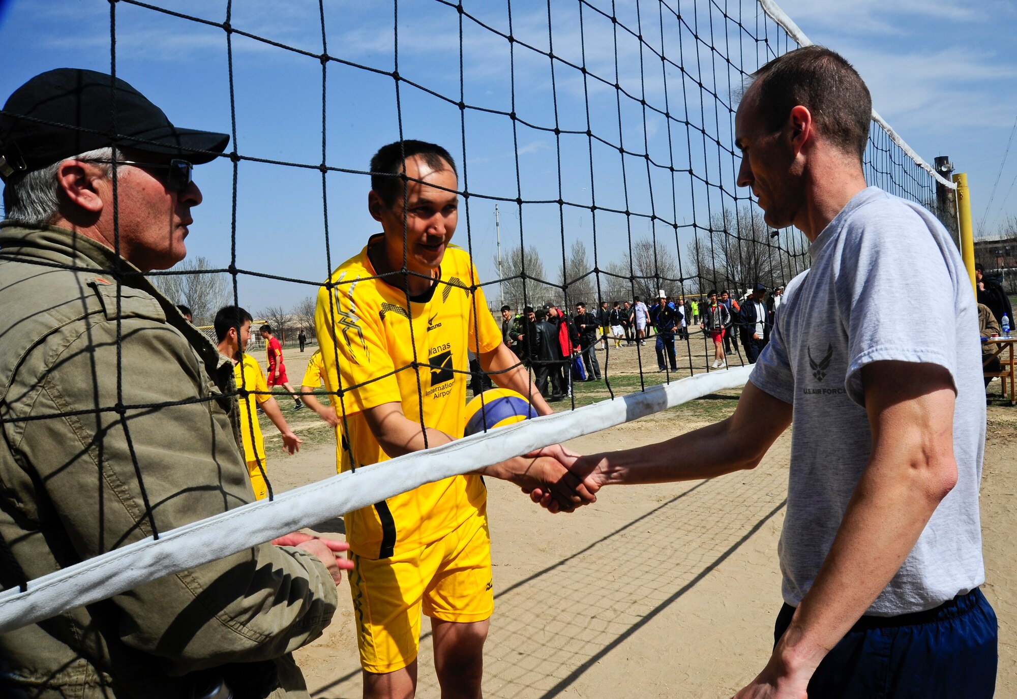 Maj. Russell Bastian shakes hands with the Manas International Airport volleyball team captain March 30, 2012, during a sports day challenge to celebrate Nowruz, the "Persian New Year" in Manas, Kyrgyzstan. Bastian is the 376th Air Expeditionary Wing Theater Security Cooperation director deployed here from Randolph Air Force Base, Texas. (U.S. Air Force photo/Staff Sgt. Angela Ruiz)