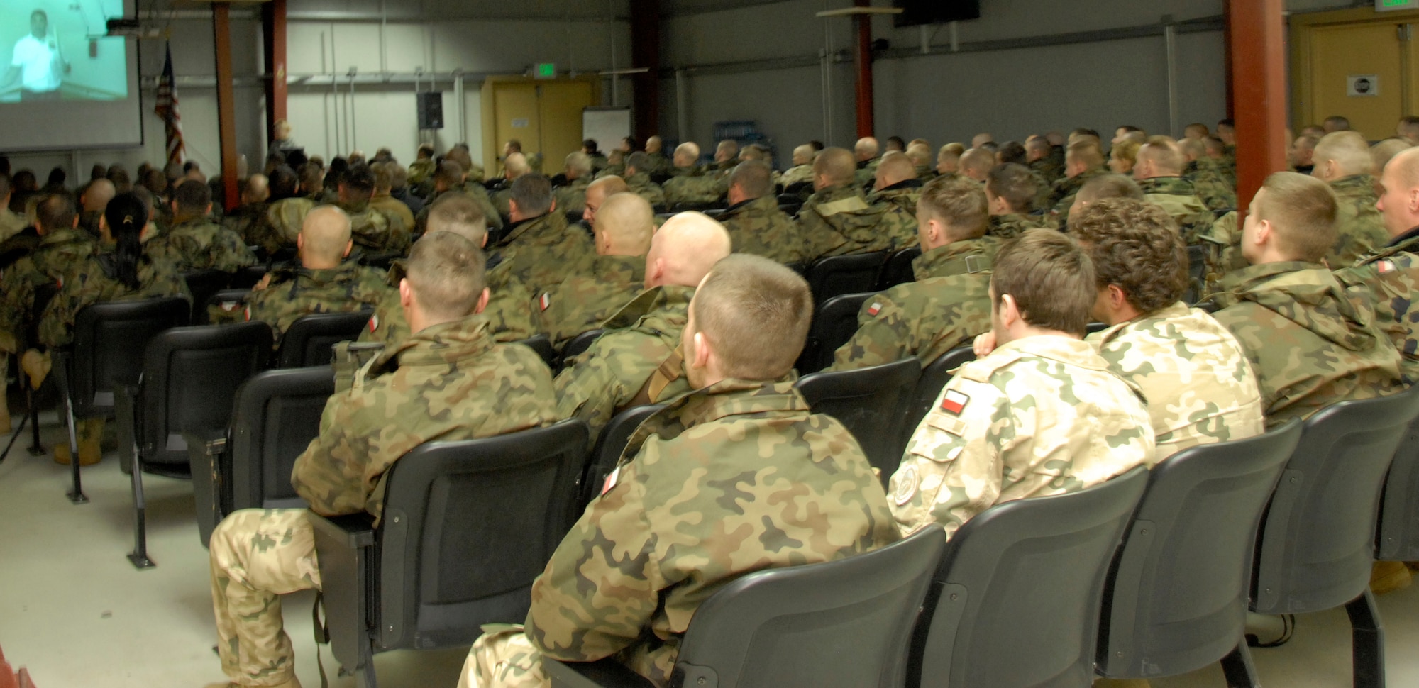 Coalition forces attend a briefing at the personnel support of contingency operations office at the Transit Center at Manas March 31, 2012. During the week of March 19 through 25, the Transit Center processed a record 19,827 service members. (U.S. Air Force photo/Senior Airman Lynsie Nichols)
