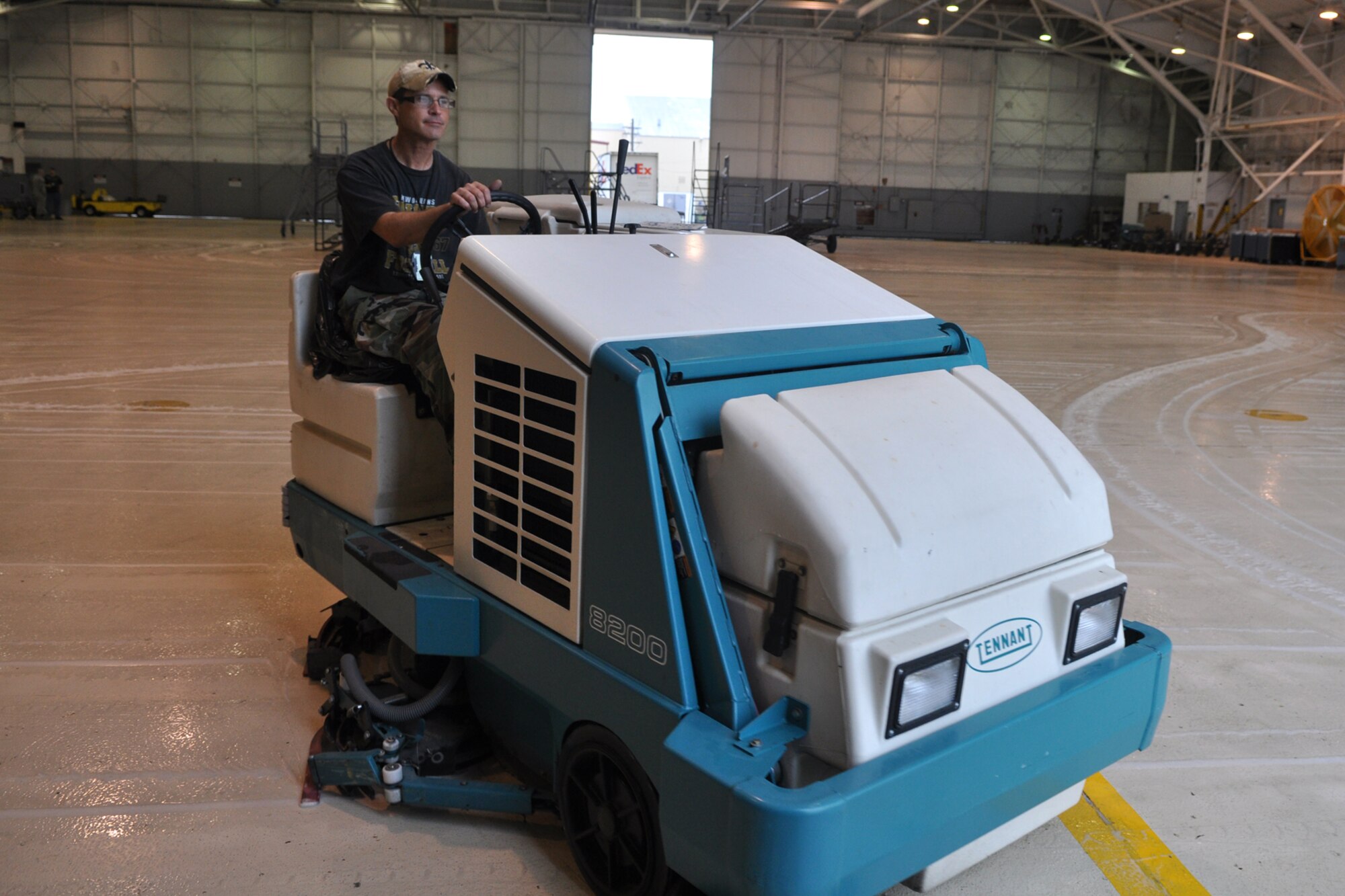 Christopher Duhe, an Air Reserve Technician at the 917th Aircraft Maintenance Squadron, cleans the floor of the A-10 Hangar at Barksdale Air Force Base, La., March 30, 2012. Although the floor in the hangar is cleaned on a regular basis, Duhe, who is also a crew chief for an A-10 Thunderbolt II, was preparing for a retirement ceremony schedule to be held in the hangar during the 917th Fighter Group’s Unit Training Assembly this weekend. (U.S. Air Force photo by Master Sgt. Jeff Walston)     