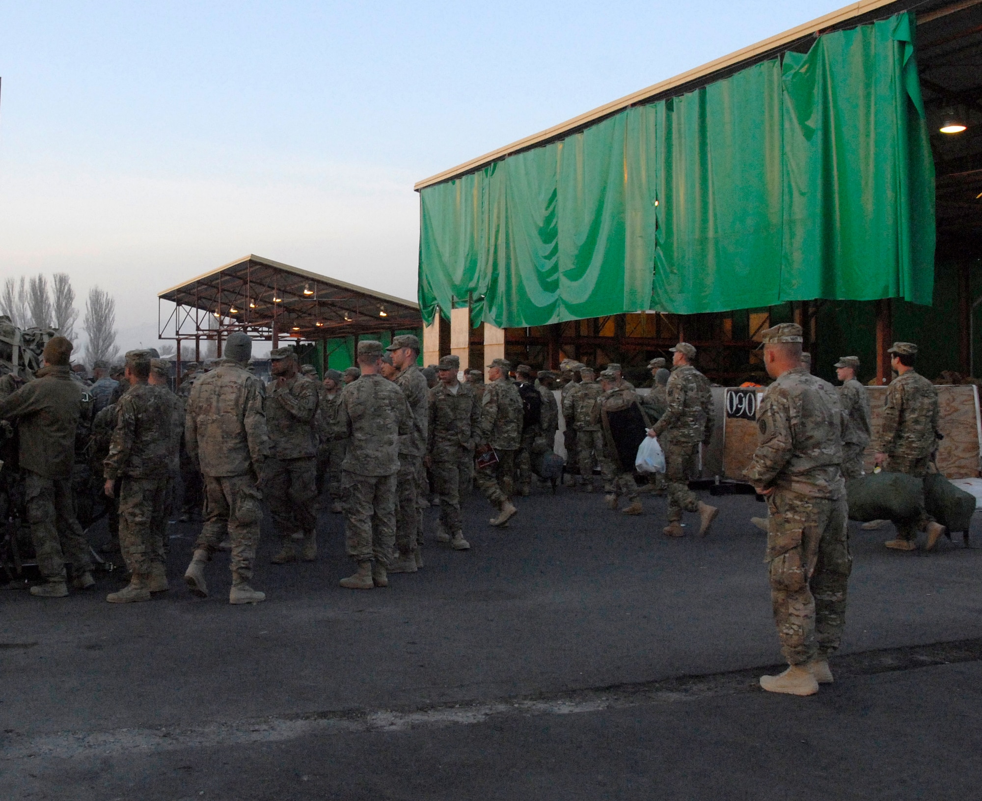 United States military members move gear in the yard at the Transit Center at Manas March 31, 2012. Service members here work side-by-side with Kyrgyz partners every day to support international efforts in Afghanistan by moving fuel, cargo and people.  Last week, the team moved a record 19,827 coalition troops, the most since the installation opened 10 years ago.(U.S. Air Force photo/Senior Airman Lynsie Nichols)