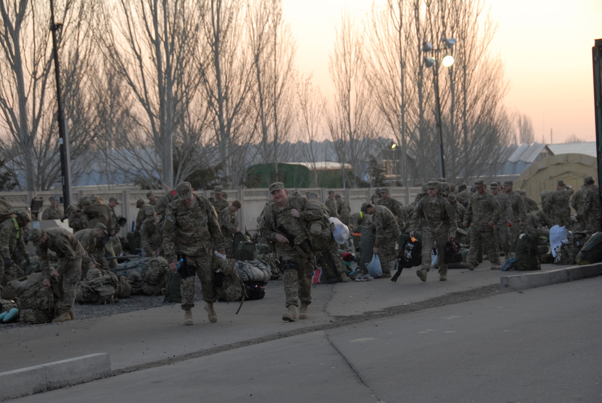 United States military members sort through their gear at the Transit Center at Manas March 31, 2012. During the previous week, the Transit Center processed a record 19,827 service members. Between March 19 and 25, various units here worked together to overcome a variety of obstacles including bad weather, maintenance delays, storage space limitations and personnel turnover.  Some of the key players included people assigned to the 376th Expeditionary Logistics Readiness Squadron, 376th Expeditionary Force Support Squadron Personnel Support of Contingency Operations office and the 817th Expeditionary Airlift Squadron.(U.S. Air Force photo/Senior Airman Lynsie Nichols)