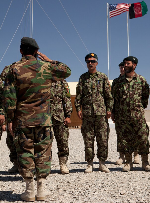 An Afghan National Army soldier from 2nd Brigade, 215th Corps stands in front of ANA 2nd Brigade staff to receive his graduation certificate during a mechanics course graduation, April 28, 2012. Thirteen soldiers attended the month-long course, learning how to repair diesel truck engines.