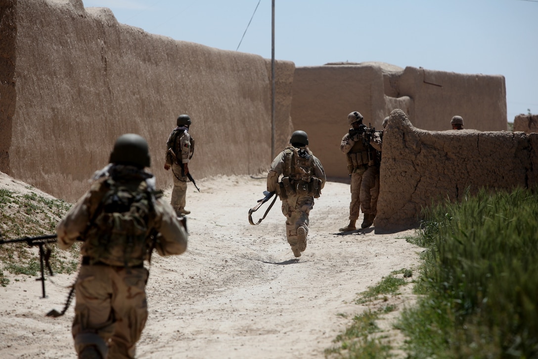 1st Lt. Devin Claridy, 3rd Platoon commander, Alpha Company, 1st Battalion, 8th Marine Regiment, provides cover-fire as Afghan National Security Forces run to a new position during Operation Reservoir Dogs, May 1, 2012. The operation took place in Sabzikar, Afghanistan. Claridy is from Akron, Ohio.