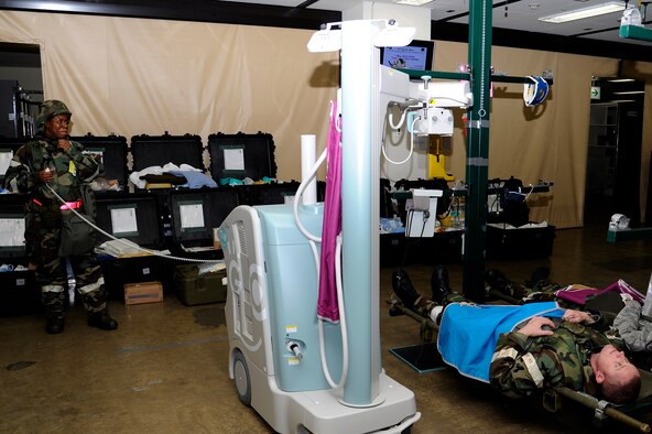 U.S. Air Force Staff Sgt. Walima Cure, left, 35th Medical Group, takes an X-ray of simulated patient Tech. Sgt. Eberhard Riebe, 35th Maintenance Operations Squadron, during an operational readiness exercise at Misawa Air Base, Japan, May 1, 2012. Treatment given to an injured servicemember within the first hour after an attack exponentially increases the member's chances of making a full recovery. (U.S. Air Force photo by Tech. Sgt. Marie Brown)