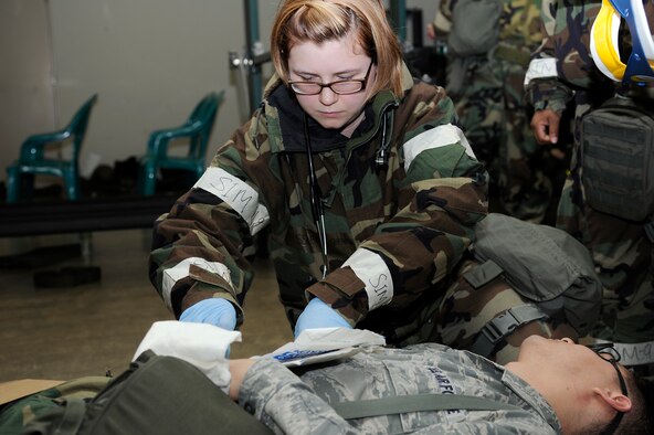 U.S. Air Force Senior Airman Erica Shearer, 35th Medical Group, treats simulated patient Staff Sgt. John Cates, 35th Maintenance Operations Squadron, during an operational readiness exercise at Misawa Air Base, Japan, May 1, 2012. The ORE is designed to test Airmen's ability to survive and operate in a deployed environment. (U.S. Air Force photo by Tech. Sgt. Marie Brown)