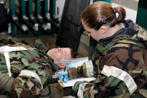 U.S. Air Force Staff Sgt. Sarah Taber, right, 35th Medical Group, writes down the diagnosis of simulated patient Staff Sgt. Sean O'Neill, 35th Maintenance Squadron, during an operational readiness exercise at Misawa Air Base, Japan, May 1, 2012. Air Force medics hone their skills to provide combat casualty care in deployed environments. (U.S. Air Force photo by Tech. Sgt. Marie Brown)