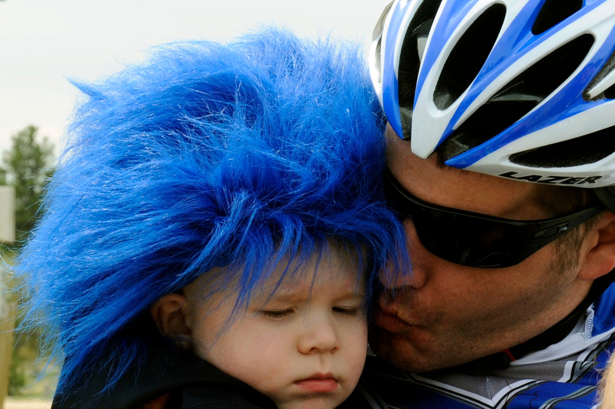 Capt. Anthony Simone gets a congratulatory kiss from his son after completing his race May 1, 2012, as part of the Warrior Games at the U.S. Air Force Academy in Colorado Springs, Colo. Simone is recovering from a traumatic brain injury and competed in the men's recumbent bike category. He finished the race with a time of 1:35:53. (U.S. Air Force photo/Tech. Sgt. Mareshah Haynes)