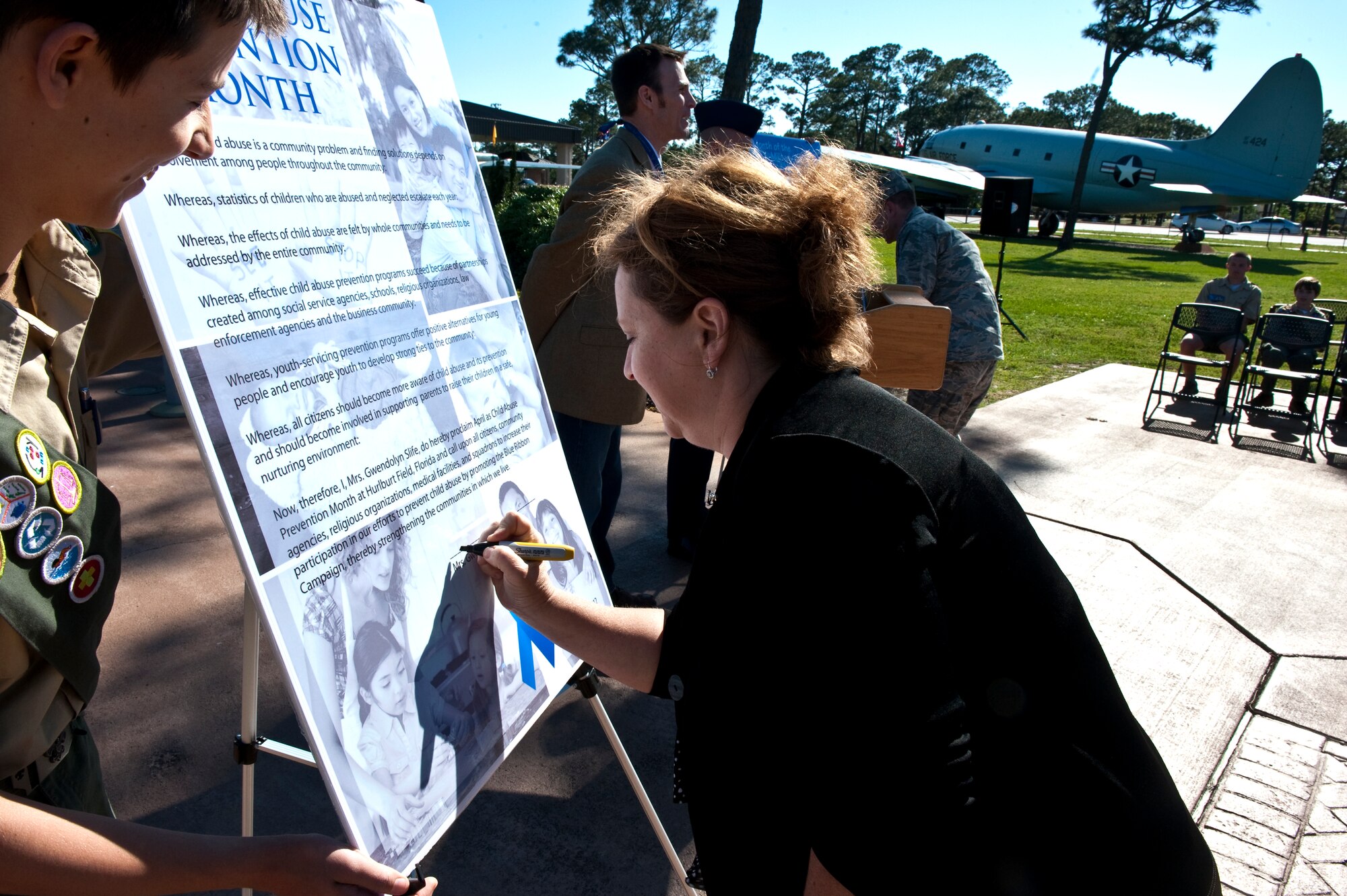 Gwendolyn Slife, wife of Col. Jim Slife, commander of 1st Special Operations Wing, signs a proclamation designating April as Child Abuse Prevention Month during a proclamation-signing ceremony at the Airpark on Hurlburt Field, Fla. April 24, 2012. According to the National Child Traumatic Stress Network’s website, April was first declared Child Abuse Prevention Month by presidential proclamation in 1983 as a time to acknowledge the importance of families and communities working together to prevent child abuse. (U.S. Air Force photo by Airman 1st Class Christopher Williams) (RELEASED)