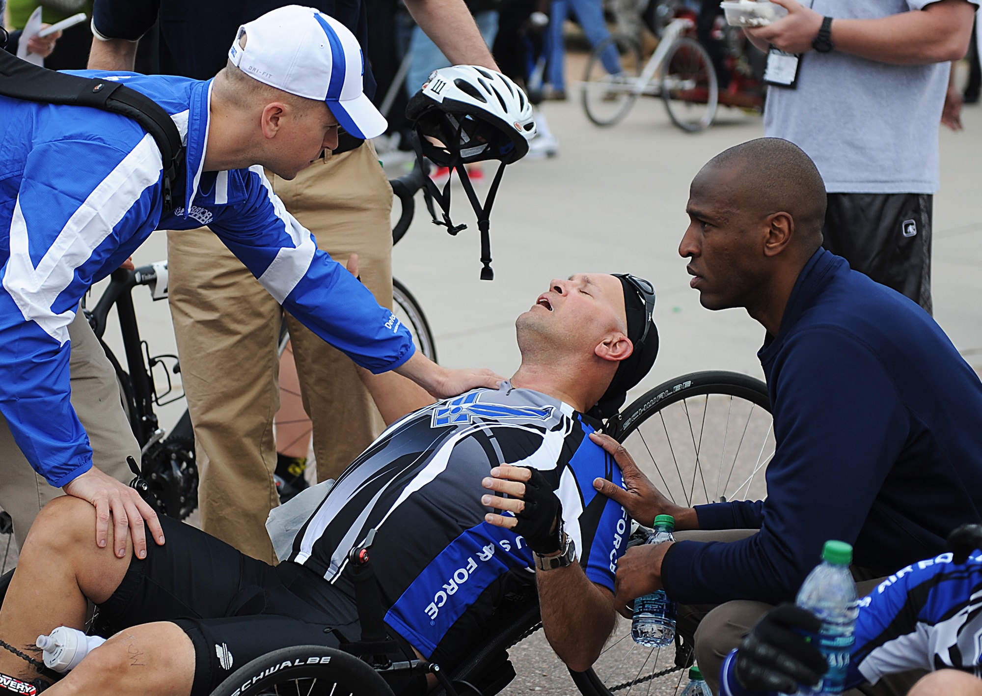 U.S. Air Force Chief Master Sgt. Damian Orslene, center, catches his breath after taking part in the recumbent cycling event of Warrior Games 2012 at the U.S. Air Force Academy in Colorado Springs, Colo., May 1, 2012. (U.S. Air Force photo by Val Gempis/Released)
