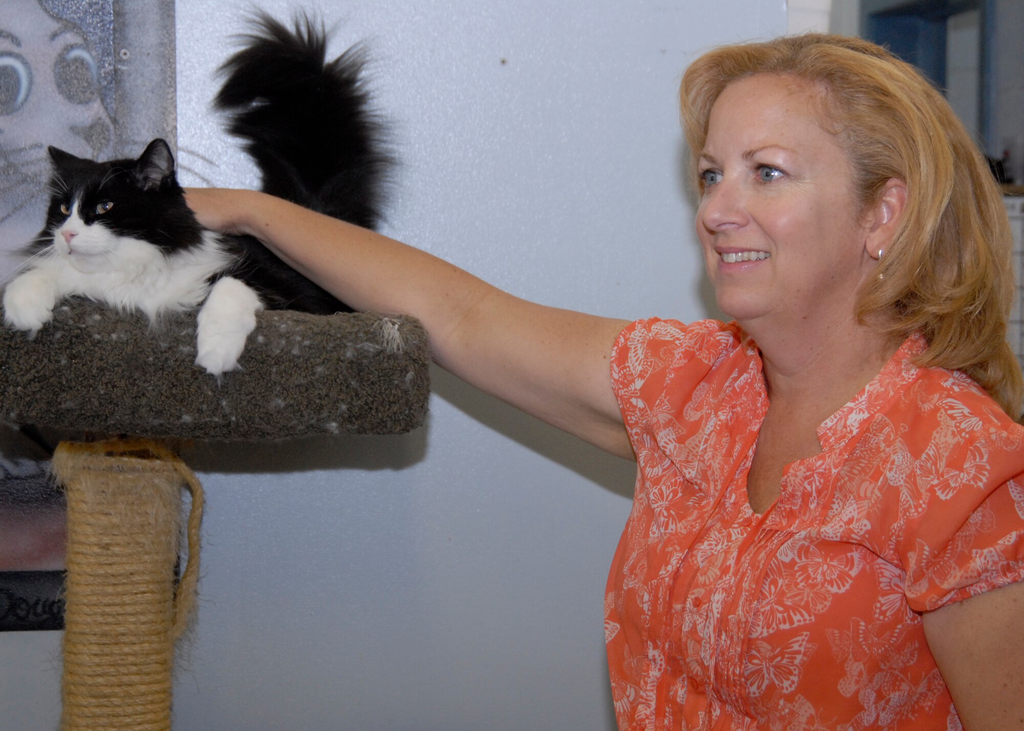 An active volunteer with the Adopt-A-Pet organization, Sandy Berry spends quality time with 5-year-old Nilla during her afternoon shift May 27. It will be two years this summer since she began volunteering at the facility. (Air Force Photo by Laura Mowry)