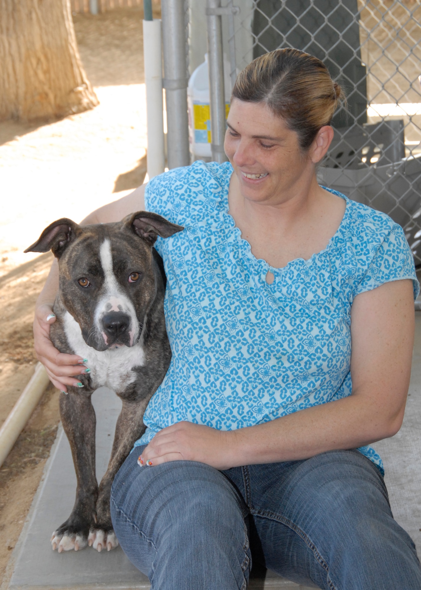 Adopt-A-Pet president, Shelley Thurmon, spends time with Sadie during the afternoon shift April 27. Thurman began volunteering in 2005 and works with approximately 20 volunteers each week to care for the animals and find them permanent, loving homes. (Air Force Photo by Laura Mowry)