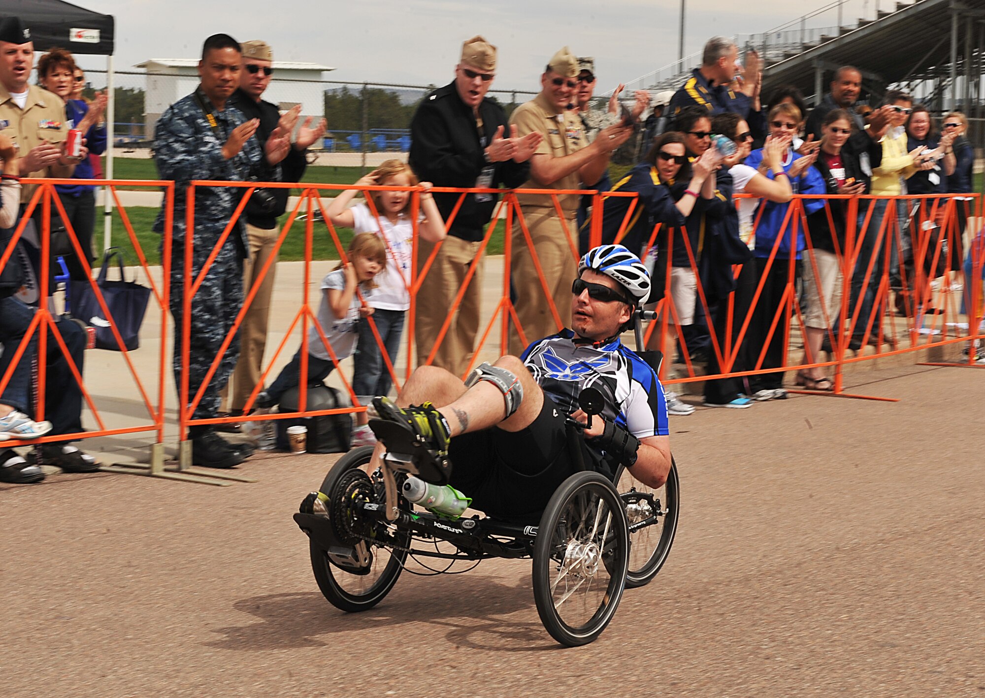 U.S. Air Force Capt. Anthony Simone is cheered by the crowd as he heads to the finish line while taking part in a cycling event of Warrior Games 2012 at the U.S. Air Force Academy in Colorado Springs, Colo., April 30, 2012. (U.S. Air Force photo by Val Gempis/Released)
