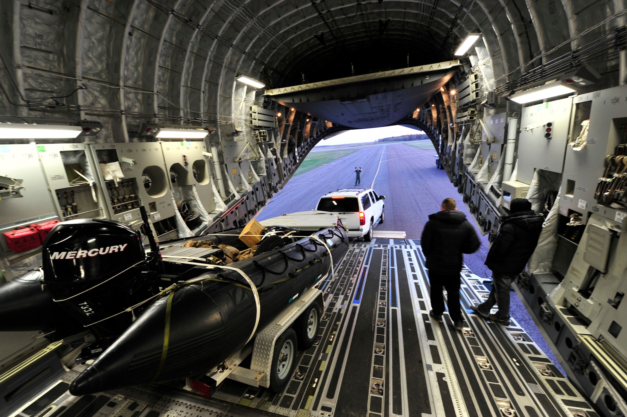 SYDNEY, Nova Scotia -- Sailors from U.S. Navy’s Explosive Ordinance Disposal Mobile Unit 12, based at Little Creek, Va., offload their rigid-hulled inflatable boat from a C-17 Globemaster III here, April 26.  The team is participating in Exercise Ardent Sentry 2012, a major NORAD and U.S Northern Command exercise focused on defense support to civil authorities. (U.S. Air Force photo by Tech. Sgt. Parker Gyokeres) (Released)