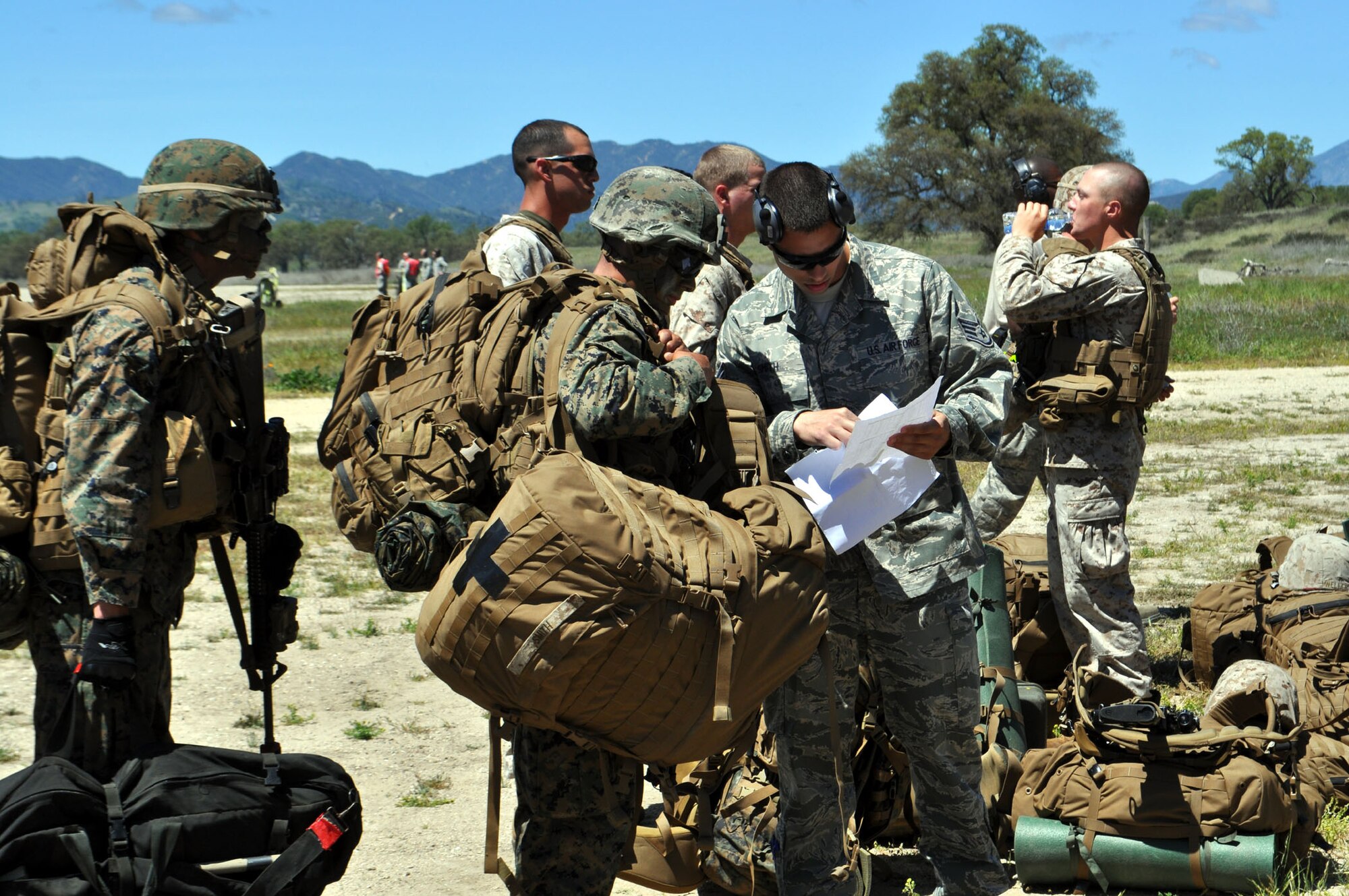 TRAVIS AIR FORCE BASE, Calif. -- Between April 16 and 21, Airmen and Marines came together in Exercise Bronco at Schoonover Landing Zone, Fort Hunter Liggett, Calif. The exercise was set up to test the capabilities of the 615th Contingency Response Wing, Travis Air Force Base, to respond to and support humanitarian operations during a disaster on home territory. Joining them were Airmen from the 60th and 349th Air Mobility Wings; Air Military Liaison officers from Fort Carson, Colo.,
and Fort Hood, Texas; Air National Guard from the Channel Islands, as well as U.S. Marines from Camp Pendleton, Calif. In addition to numerous ground equipment, the exercise used C-17 Globemaster III aircraft flown by total force crews from Travis, and the Marines C-130Js and MV-22 Ospreys. Coordination between the services gave the participants the unique opportunity to test their combat skills in a realistic environment. (U.S. Air Force photos/Senior Master Sgt. Ellen Hatfield)