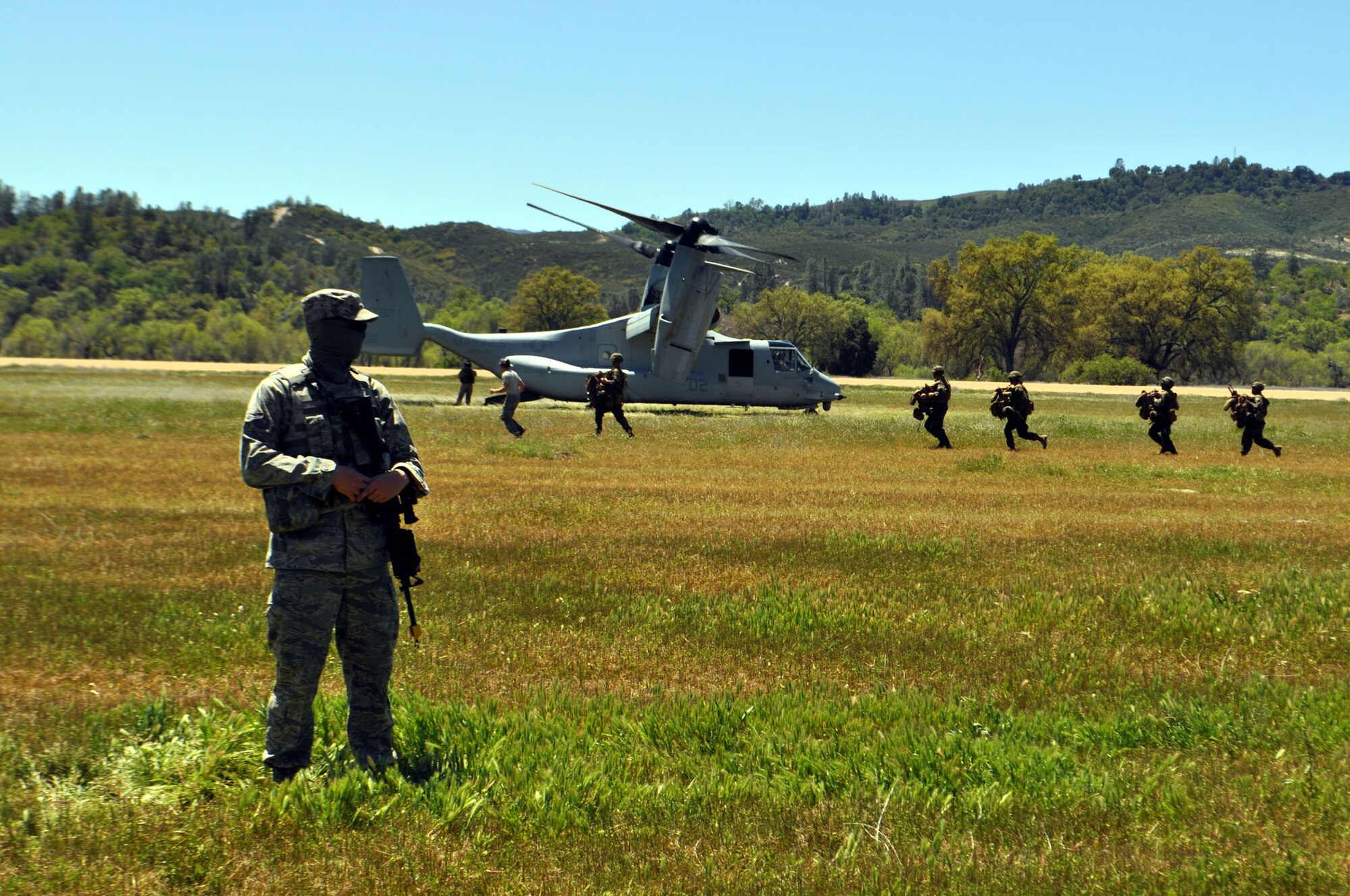TRAVIS AIR FORCE BASE, Calif. -- Between April 16 and 21, Airmen and Marines came together in Exercise Bronco at Schoonover Landing Zone, Fort Hunter Liggett, Calif. The exercise was set up to test the capabilities of the 615th Contingency Response Wing, Travis Air Force Base, to respond to and support humanitarian operations during a disaster on home territory. Joining them were Airmen from the 60th and 349th Air Mobility Wings; Air Military Liaison officers from Fort Carson, Colo.,
and Fort Hood, Texas; Air National Guard from the Channel Islands, as well as U.S. Marines from Camp Pendleton, Calif. In addition to numerous ground equipment, the exercise used C-17 Globemaster III aircraft flown by total force crews from Travis, and the Marines C-130Js and MV-22 Ospreys. Coordination between the services gave the participants the unique opportunity to test their combat skills in a realistic environment. (U.S. Air Force photos/Senior Master Sgt. Ellen Hatfield)