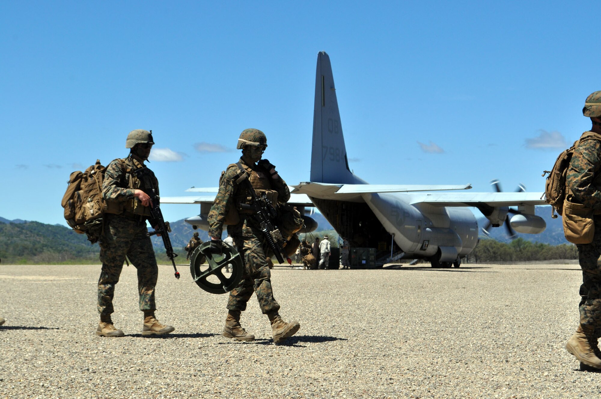 TRAVIS AIR FORCE BASE, Calif. -- Between April 16 and 21, Airmen and Marines came together in Exercise Bronco at Schoonover Landing Zone, Fort Hunter Liggett, Calif. The exercise was set up to test the capabilities of the 615th Contingency Response Wing, Travis Air Force Base, to respond to and support humanitarian operations during a disaster on home territory. Joining them were Airmen from the 60th and 349th Air Mobility Wings; Air Military Liaison officers from Fort Carson, Colo.,
and Fort Hood, Texas; Air National Guard from the Channel Islands, as well as U.S. Marines from Camp Pendleton, Calif. In addition to numerous ground equipment, the exercise used C-17 Globemaster III aircraft flown by total force crews from Travis, and the Marines C-130Js and MV-22 Ospreys. Coordination between the services gave the participants the unique opportunity to test their combat skills in a realistic environment. (U.S. Air Force photos/Senior Master Sgt. Ellen Hatfield)