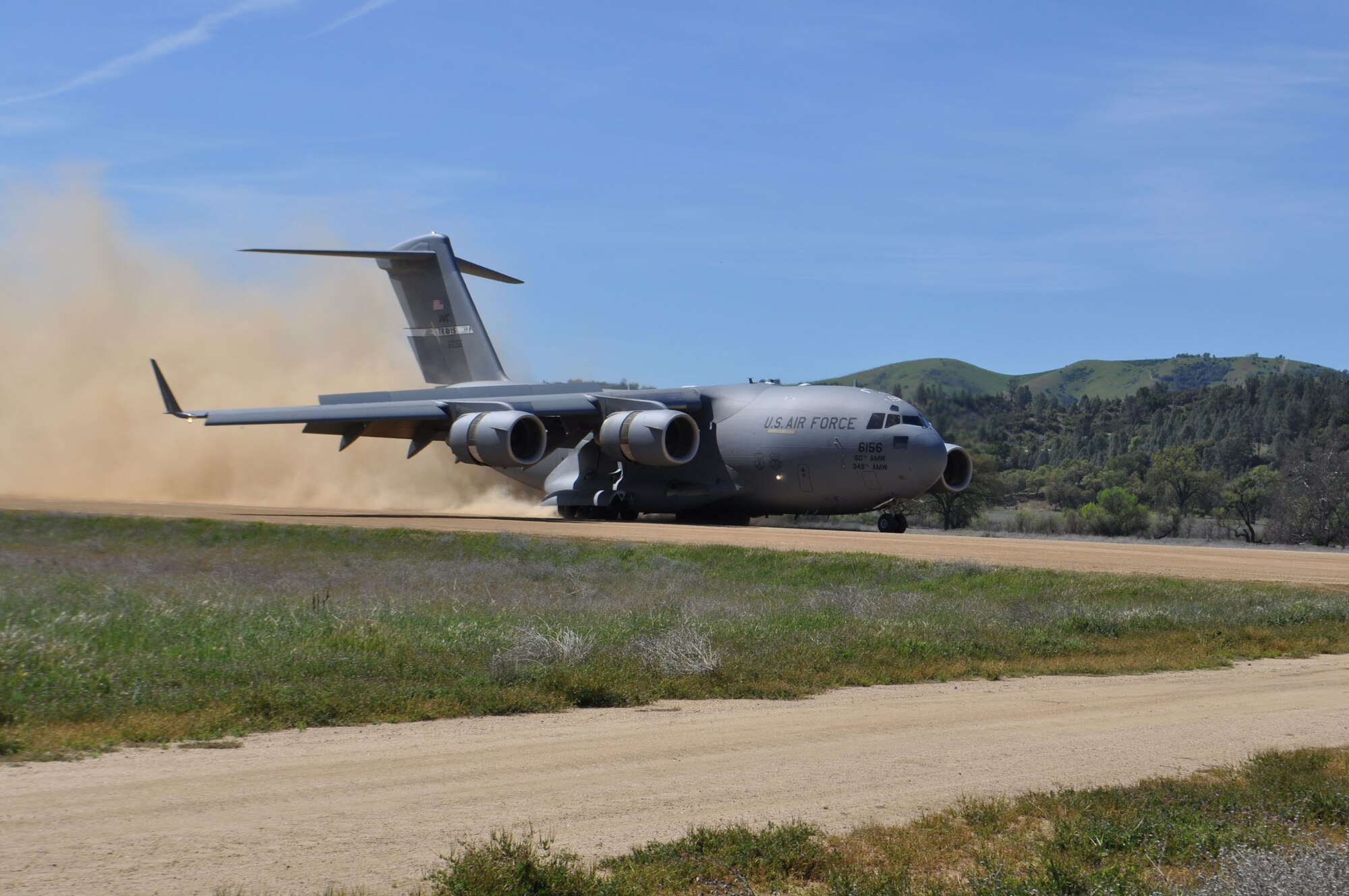 TRAVIS AIR FORCE BASE, Calif. -- Between April 16 and 21, Airmen and Marines came together in Exercise Bronco at Schoonover Landing Zone, Fort Hunter Liggett, Calif. The exercise was set up to test the capabilities of the 615th Contingency Response Wing, Travis Air Force Base, to respond to and support humanitarian operations during a disaster on home territory. Joining them were Airmen from the 60th and 349th Air Mobility Wings; Air Military Liaison officers from Fort Carson, Colo.,
and Fort Hood, Texas; Air National Guard from the Channel Islands, as well as U.S. Marines from Camp Pendleton, Calif. In addition to numerous ground equipment, the exercise used C-17 Globemaster III aircraft flown by total force crews from Travis, and the Marines C-130Js and MV-22 Ospreys. Coordination between the services gave the participants the unique opportunity to test their combat skills in a realistic environment. (U.S. Air Force photos/Senior Master Sgt. Ellen Hatfield)