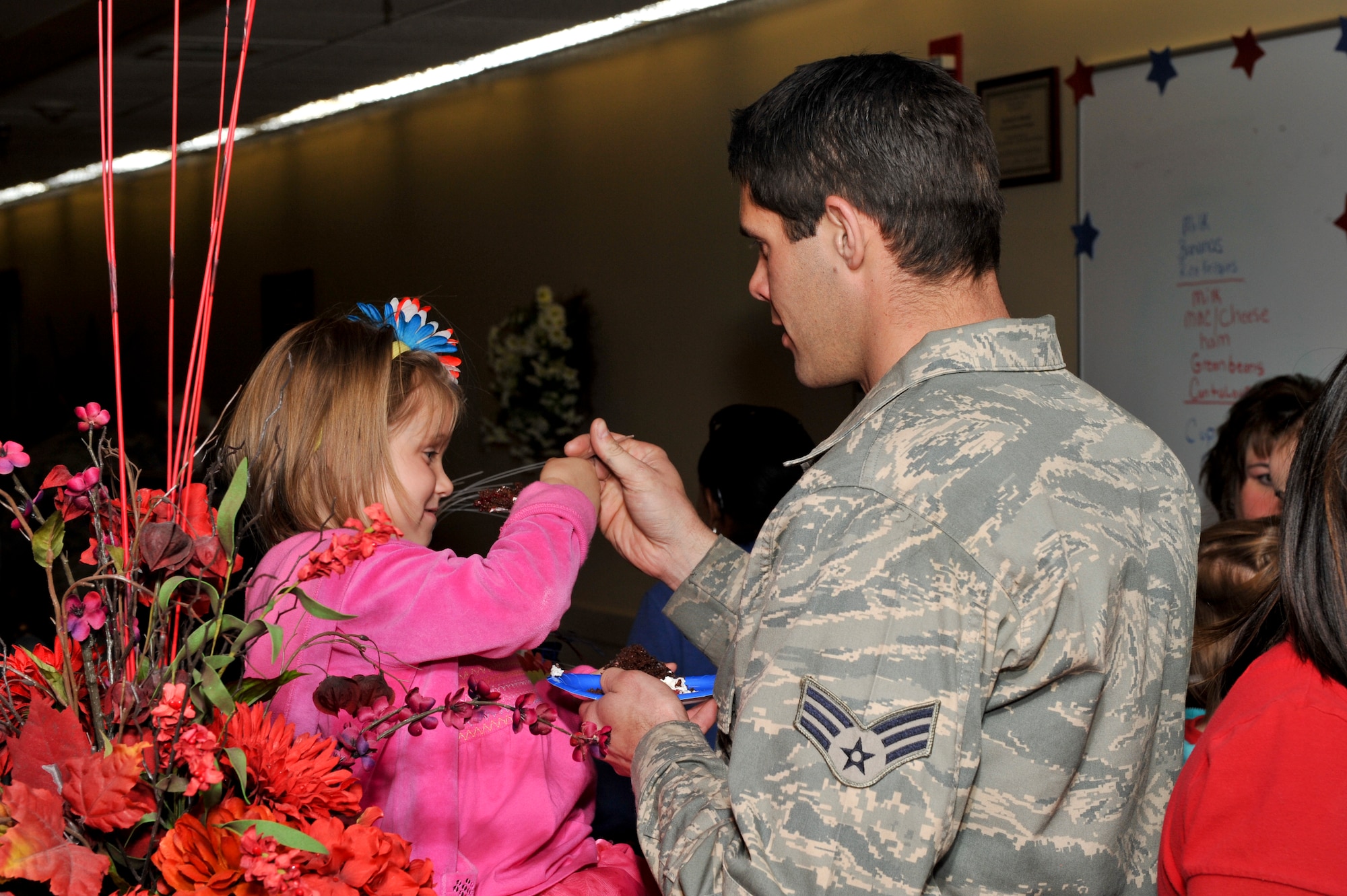 BUCKLEY AIR FORCE BASE, Colo. -- Senior Airman Michael Hopp, 140th Maintenance Squadron phase technician, feeds his daughter Kayla, age 4, cake at the Buckley Child Development Center’s Month of the Military Child kick-off celebration, March 30, 2012.  Buckley CDCs encouraged parents to participate in events throughout the month of April. (U.S. Air Force photo by Airman 1st Class Phillip Houk)  