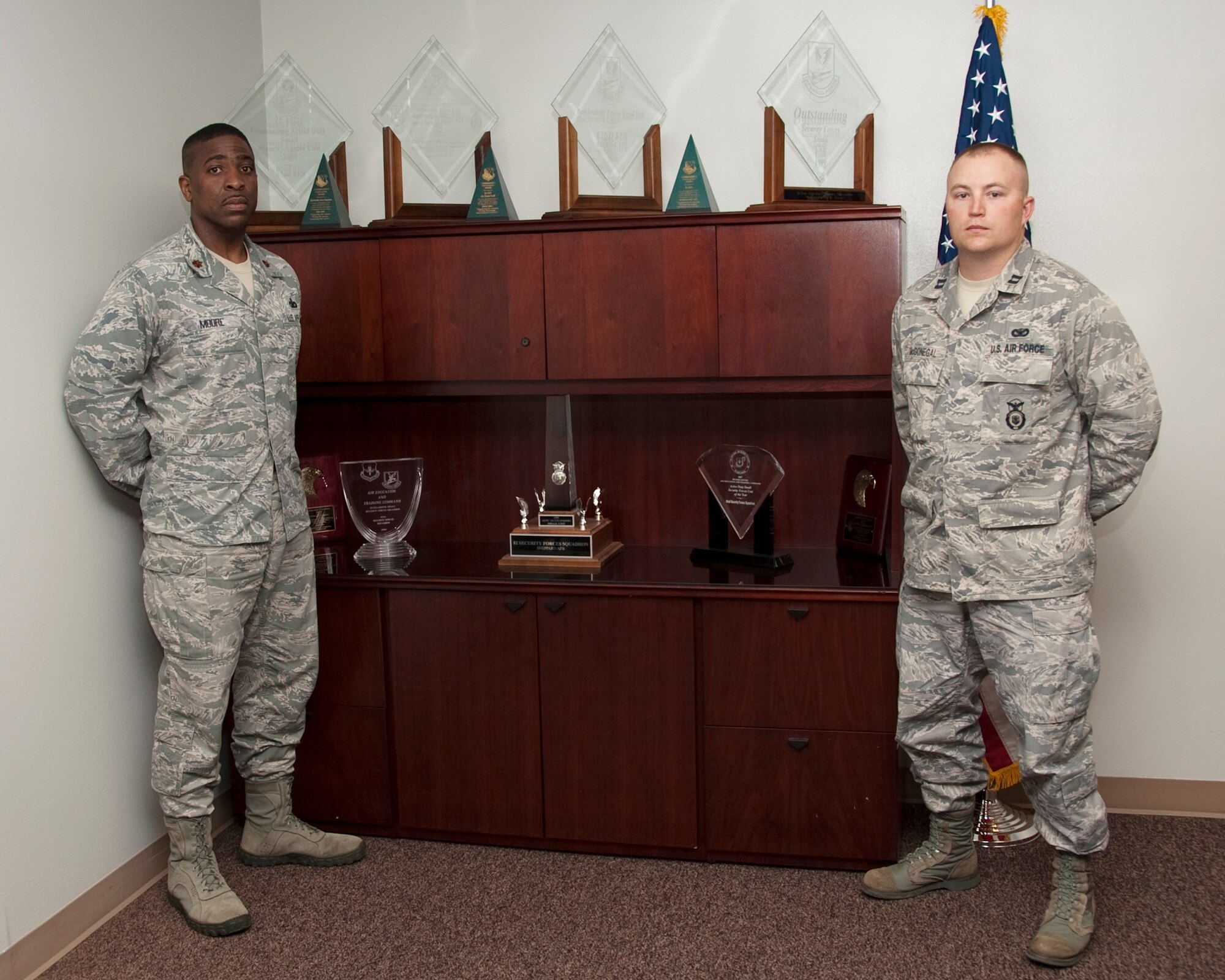 Major Robert Moore (left) stands with Capt. Jack McGonegal, 82nd Security Forces Squadron with their unit award showcase where previous AETC and Air Force Small Unit and other awards are displayed on April 27, 2012.  Winners of the 2011 AETC Small SF Unit award, the 82nd SFS has won the AETC Small SF Unit Award six times and the Air Force Small SF Unit Award three times.(U.S. Air Force photo/Frank H. Carter)