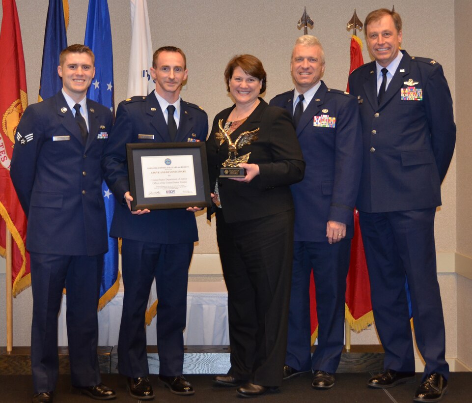 WRIGHT-PATTERSON AIR FORCE BASE, Ohio - Lt. Col. Gregory Baxley, 445th Airlift Wing Judge Advocate Office, and Col. Stephen Goeman, 445th AW commander, congratulate Mary Ann Wilsbacher, U.S. Department of Justice, Office of the U.S. Trustee, for receiving the Above and Beyond Award at the Ohio ESGR 2012 Annual Employer Recognition Dinner March 31. Wilsbacher is the employer of Senior Airman Matthew McDonald and Maj. Jeremy Flannery, both from the 445th Airlift Wing Judge Advocate General Office. (U.S. Air Force photo/Lt. Col. Cynthia Harris)