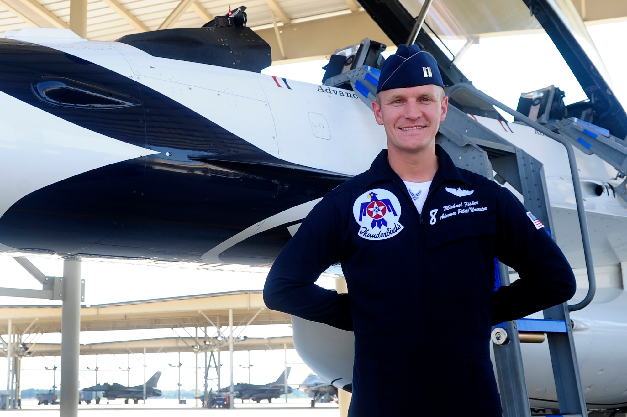 U.S. Air Force Capt. Michael Fisher, advance pilot and narrator for the U.S. Air Force Air Demonstration Squadron Thunderbirds, stands next to his jet for a photo after landing at Shaw Air Force Base, S.C., May 1, 2012. Fisher, a native of Vancouver, Wash., and the pilot of the number Eight jet, is the first to arrive at Shaw for the upcoming Shaw Air Expo that will be open to the public on May 5 and 6. May. The Thunderbirds will highlight the two-day event, but other acts include the Army Golden Knights, the Geico Skytypers, an airpower demonstration and various vintage aircraft.. (U.S. Air Force photo by Airman 1st Class Hunter Brady/Released)