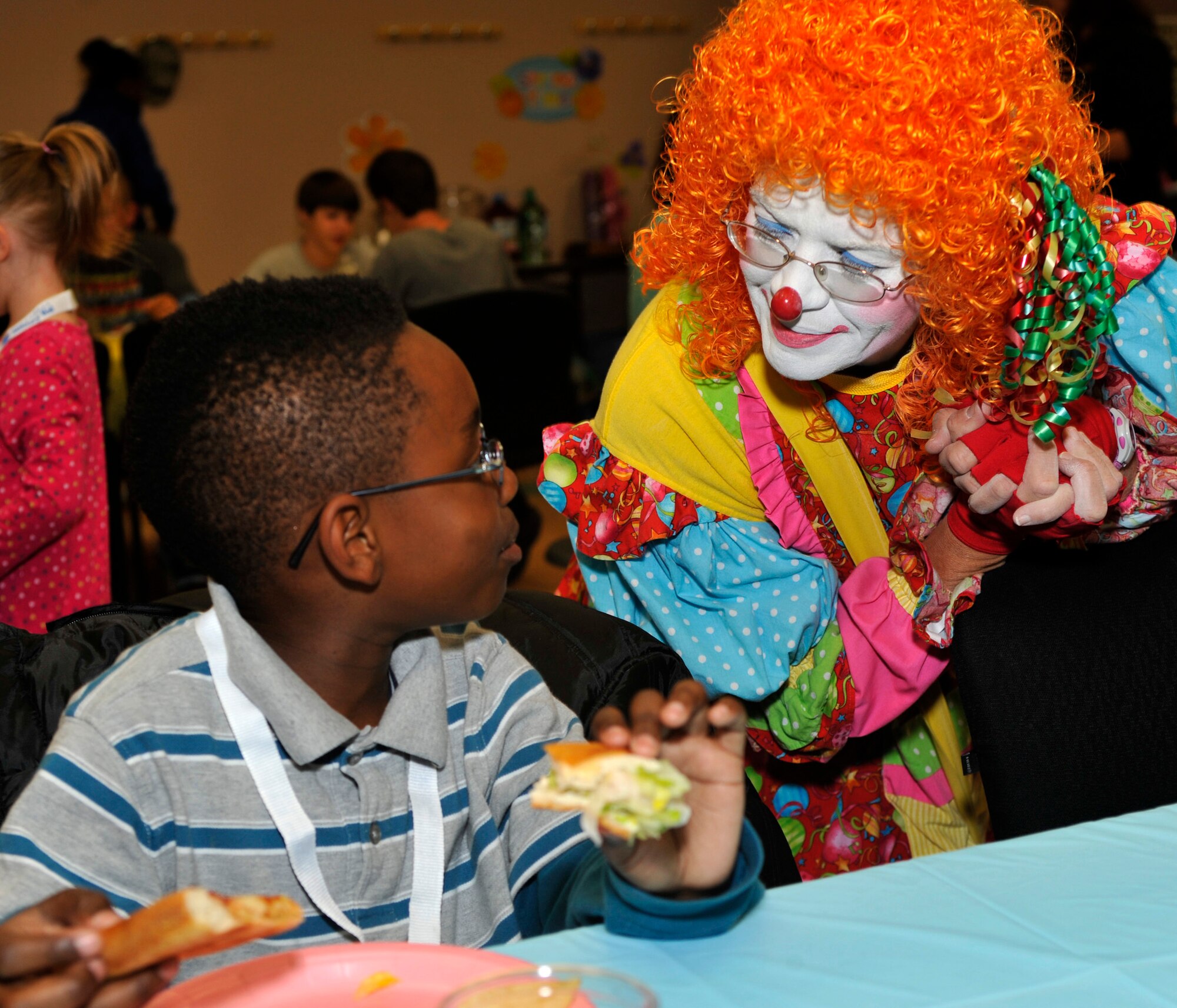 Kalif Dunnah, 8, interacts with "Snippy Doodles" during the Deployed Families' Dinner at the Youth Center April 26, 2012, at Dover Air Force Base, Del. The dinner is hosted quarterly by the Airman Family Readiness Center. (U.S. Air Force photo by Tech. Sgt. Chuck Walker)