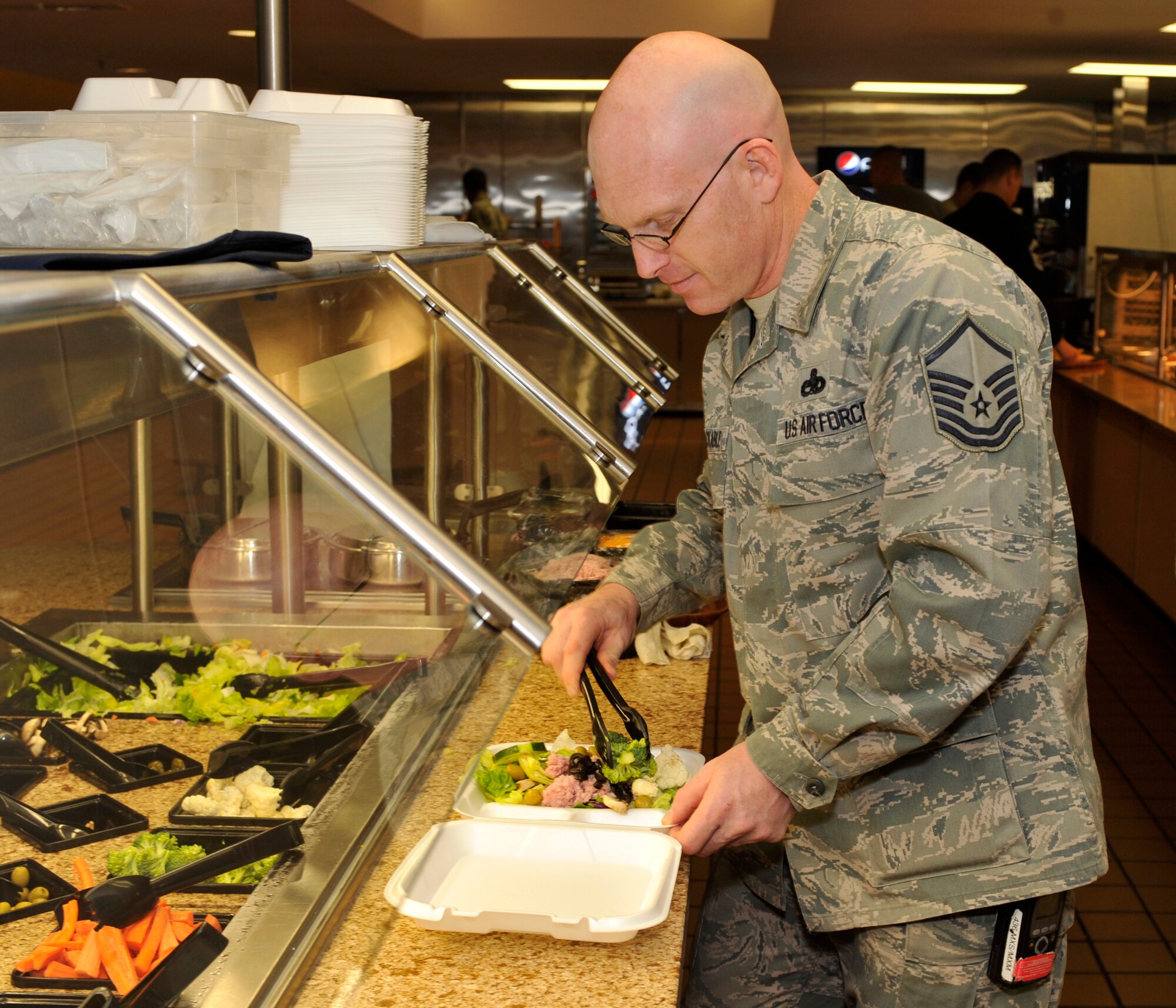 Master Sgt. James Stackable of the 436th Maintenance Squadron prepares at the Patterson Dining Facility April 30, 2012, at Dover Air Force Base, Del. The dining facility is promoting "Go for Green" foods to encourage Team Dover to eat healthy. (U.S. Air Force photo by Tech. Sgt. Chuck Walker)