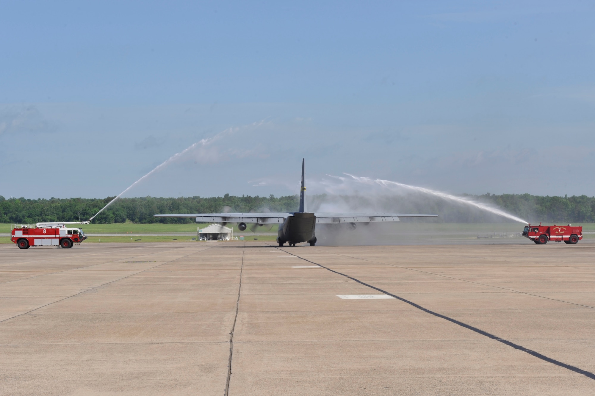 C-130E 61-2358 gets washed down by fire trucks as it taxies down the flightline May 1, 2012, at Little Rock Air Force Base, Ark. (U.S. Air Force photo by Airman 1st Class Rusty Frank)