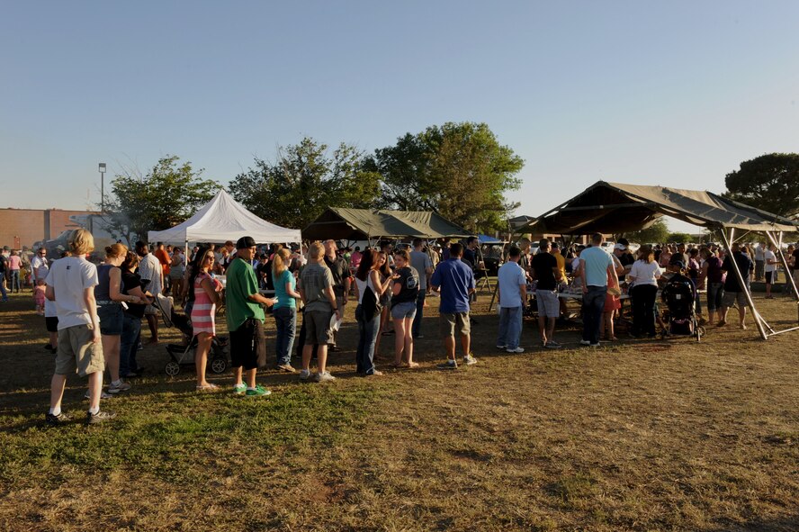 Base personnel and their families wait in line for food during the Rockin’ in the Park festival April 27, 2012, at Dyess Air Force Base, Texas. The festival offered free food and live entertainment to all military members, base civilian employees and family members. (U.S. Air Force photo by Staff Sgt. Richard P. Ebensberger/ Released)