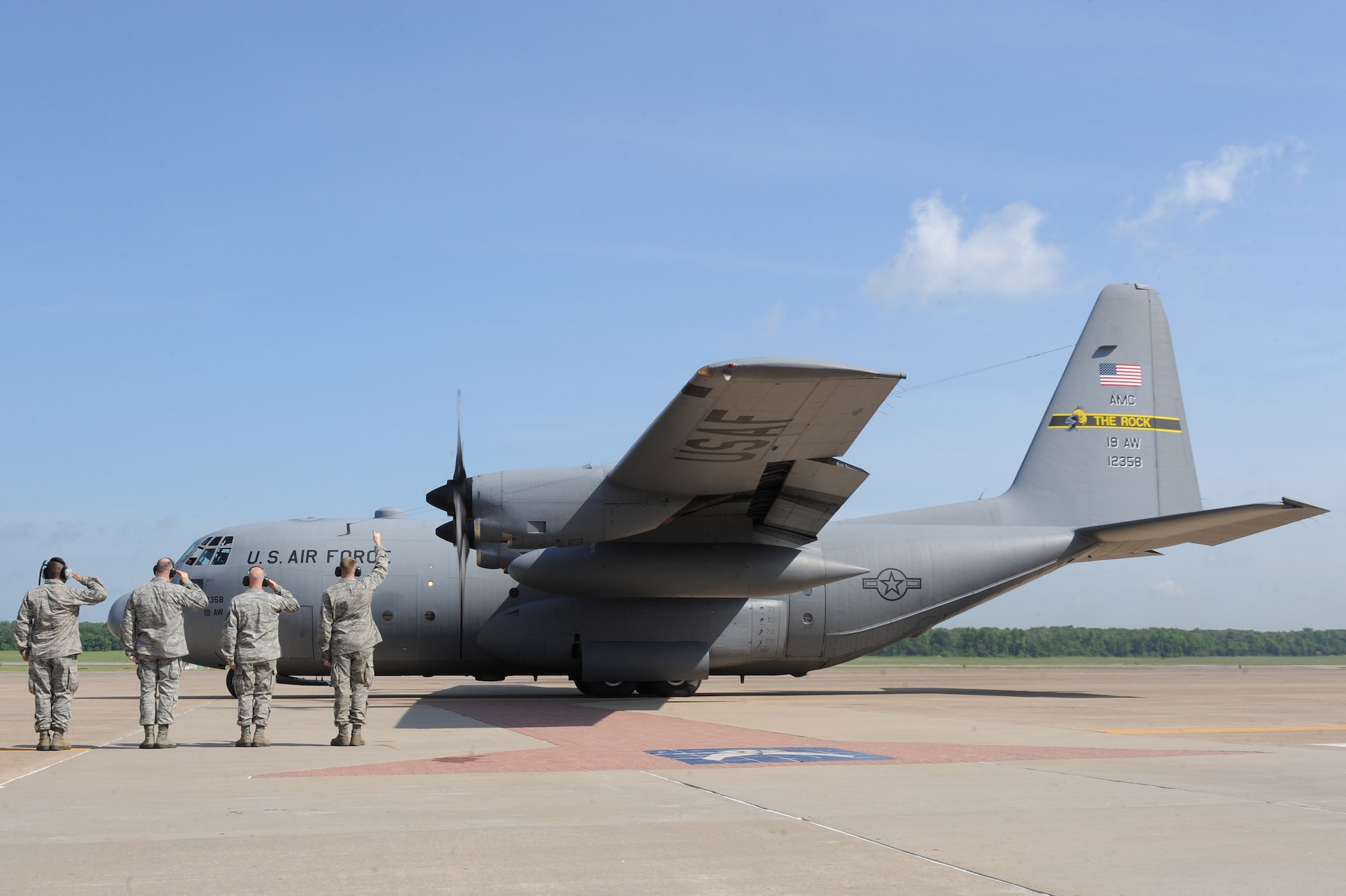 Base Airmen salute the C-130E 61-2358 during its retirement ceremony May 1, 2012. (U.S. Air Force photo by Tech. Sgt. Chad Chisholm)