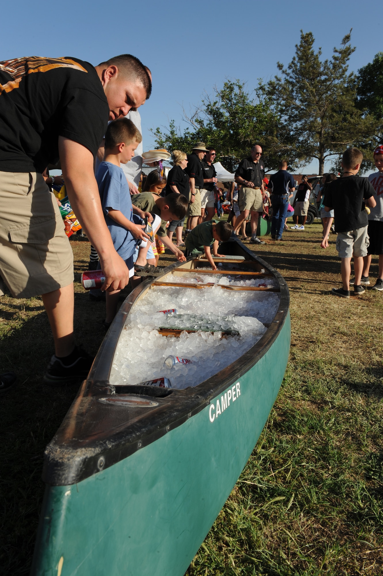 Base personnel and their families reach for refreshments during the Rockin’ in the Park festival April 27, 2012, at Dyess Air Force Base, Texas. The festival offered free food and live entertainment to all military members, base civilian employees and family members. (U.S. Air Force photo by Staff Sgt. Richard P. Ebensberger/ Released)