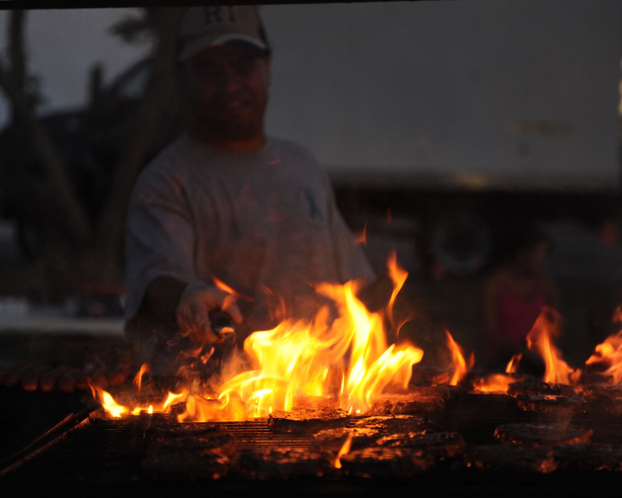 U.S. Air Force Master Sgt. Alexis Garcia, 7th Operations Group first sergeant, grills hamburgers during the Rockin’ in the Park festival April 27, 2012, at Dyess Air Force Base, Texas. The festival offered free food and live entertainment to all military members, base civilian employees and family members. (U.S. Air Force photo by Staff Sgt. Richard P. Ebensberger/ Released)