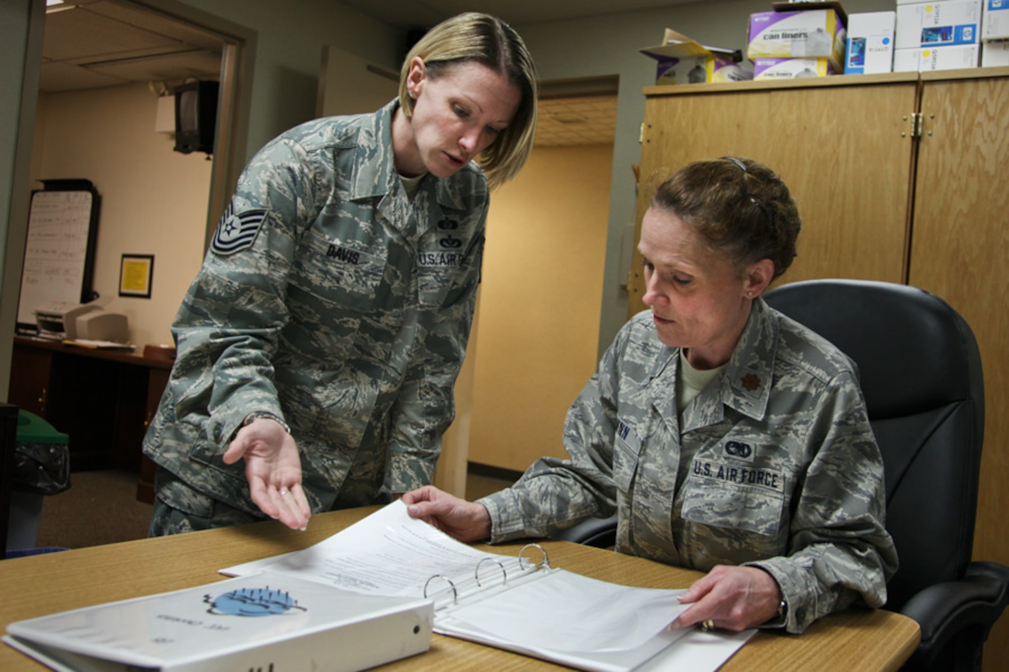 Tech. Sgt. Jessica Davis, left, an emergency management specialist attached to 911th Civil Engineering Squadron, reviews the 911th Comprehensive Emergency Management Plan with the newly assigned Logistics Readiness Group commander, Maj. Tanaka Dunn, here, May 1, 2012. The CEMP, also known as the 10-2, identifies procedures to respond to, and recover from, major accidents like natural disasters and terrorist attacks, but also provides guidance for possible use of chemical, biological, radiological and nuclear agents. The Air Force Civil Engineer is responsible for all CE contingency response programs and policy implementation. (U.S. Air Force photo by Tech. Sgt. Ralph Van Houtem/Released)