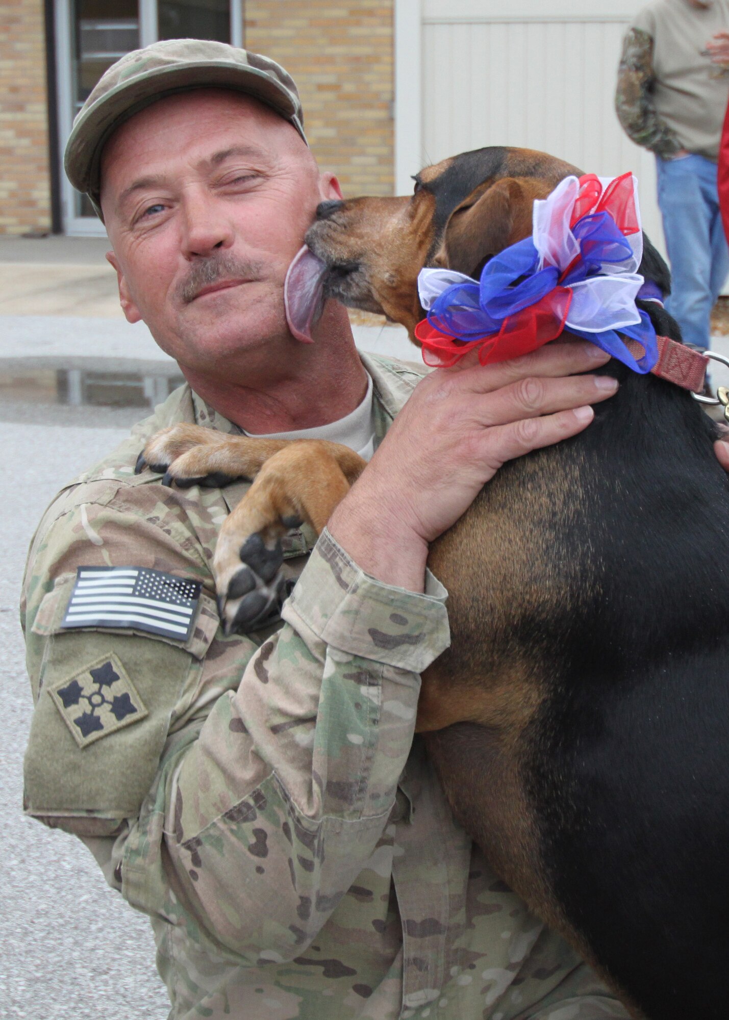 Master Sgt. Joe Holloway, 131st Bomb Wing Maintenance Group, is greeted by his dog Lucy on his return after a nearly yearlong deployment to Afghanistan.  131st Bomb Wing members of Agricultral Development Team-Five returned from deployment April 20 to Lambert Air National Guard Base-Saint Louis.  An official welcome ceremony was held at the Ike Skelton Training Site, Missouri National Guard Headquarters-Jefferson City, April 25.  (Photo by Chief Master Sgt. John Youngstrom).