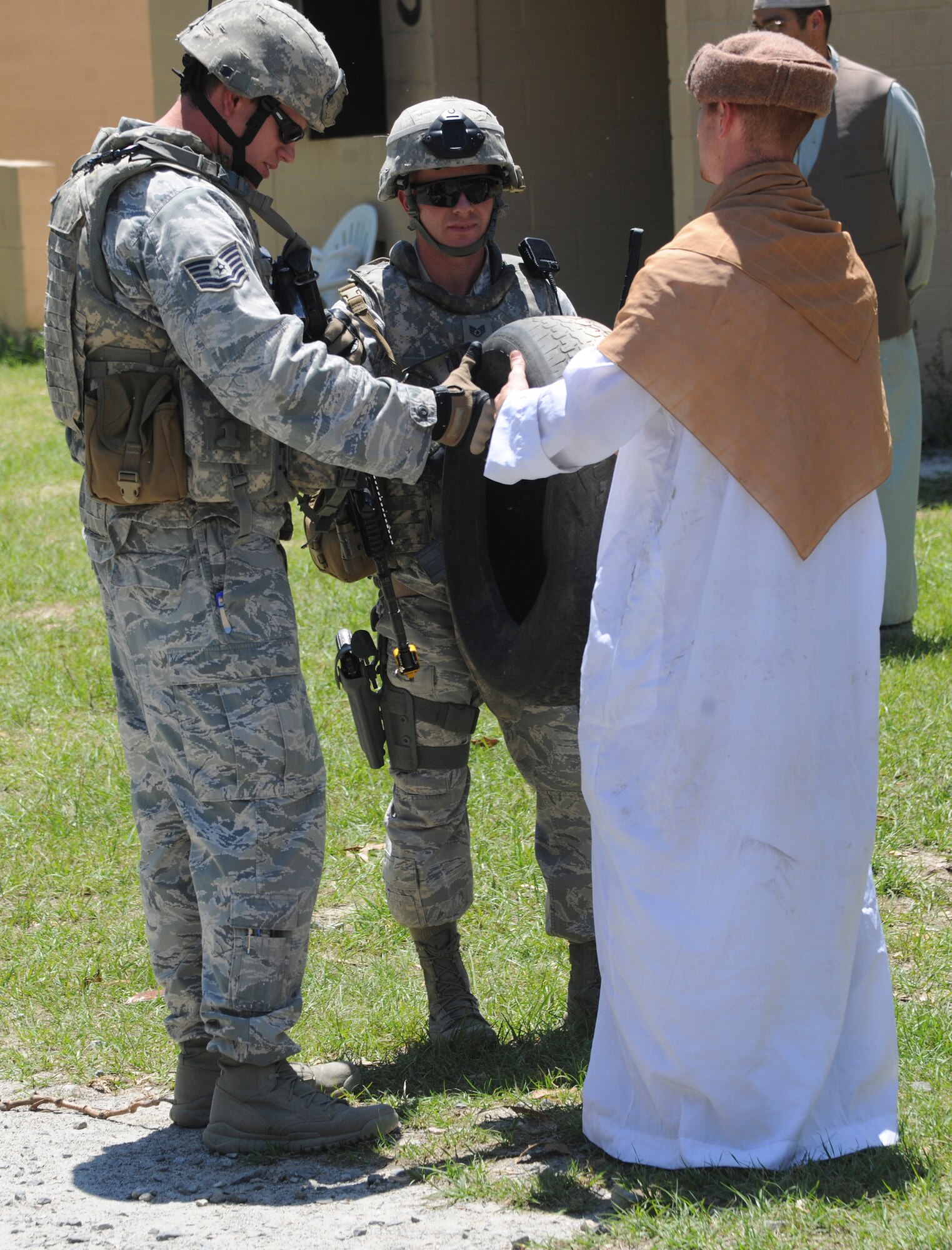 U.S. Air Force Airmen from the 820th Base Defense Group interact with a role player during the 820th BDG operational readiness exercise at Moody Air Force Base, Ga., April 26, 2012. Interacting with locals was one of many scenarios to test the 820th BDG during the ORE. (U.S. Air Force photo by Airman 1st Class Paul Francis/Released)
