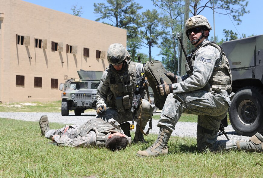U.S. Air Force Airmen from the 820th Base Defense Group check and secure an Airman with simulated injuries during the 820th BDG operational readiness exercise at Moody Air Force Base, Ga., April 26, 2012. Members from the 820th BDG were evaluated on how they interacted with locals, responded to a sniper attack, and provided self-aid and buddy care procedures. (U.S. Air Force photo by Airman 1st Class Paul Francis/Released)
