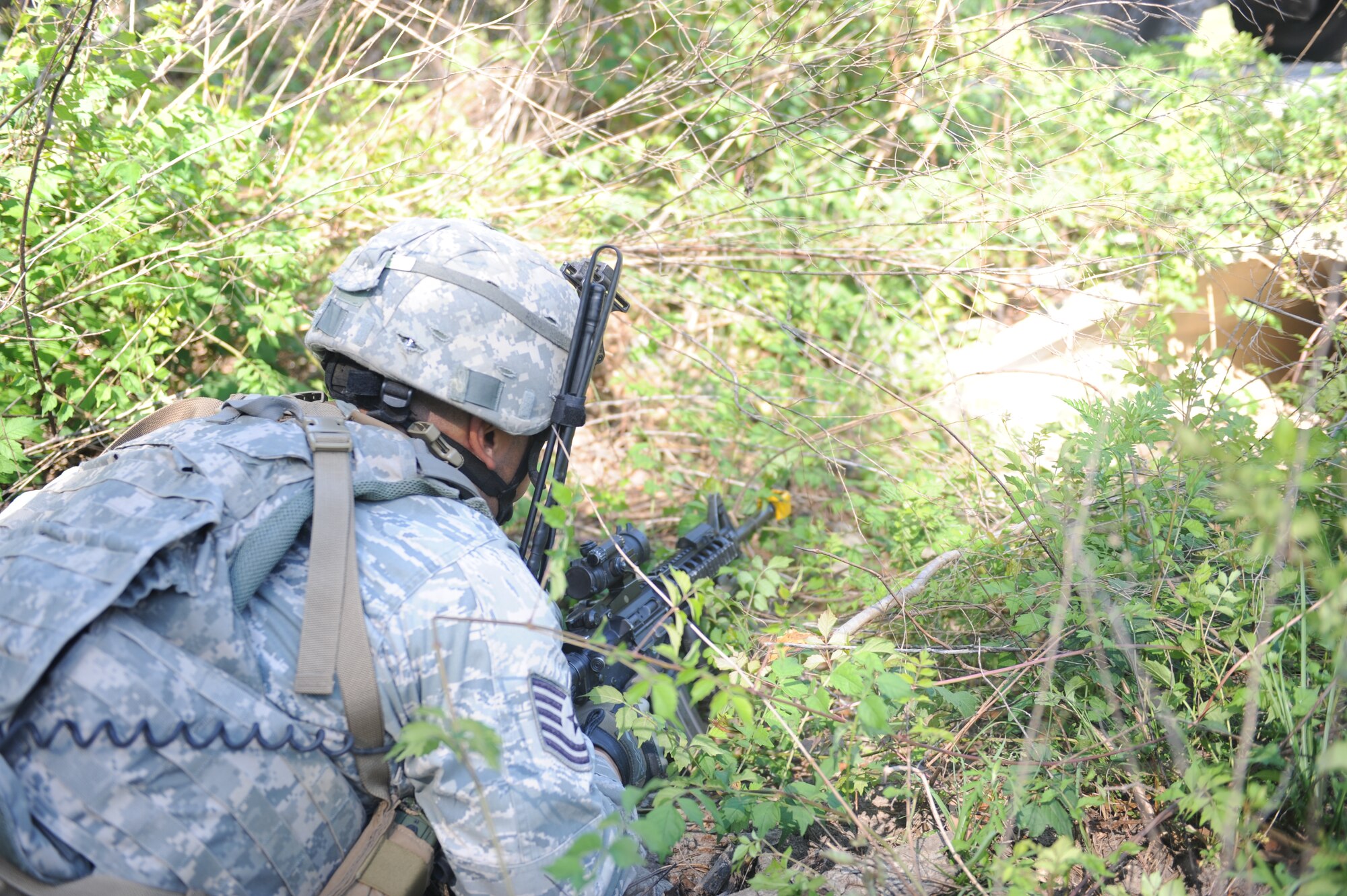 U.S. Air Force Tech. Sgt. Eric Rodriguez, 820th Base Defense Group, looks down a storm drain during an 820th operational readiness exercise at Moody Air Force Base, Ga., April 27, 2012. During the ORE, the 820th BDG was evaluated on how well they detect and react to improvised explosive devices in a combat zone. (U.S. Air Force photo by Airman 1st Class Douglas Ellis/Released)
