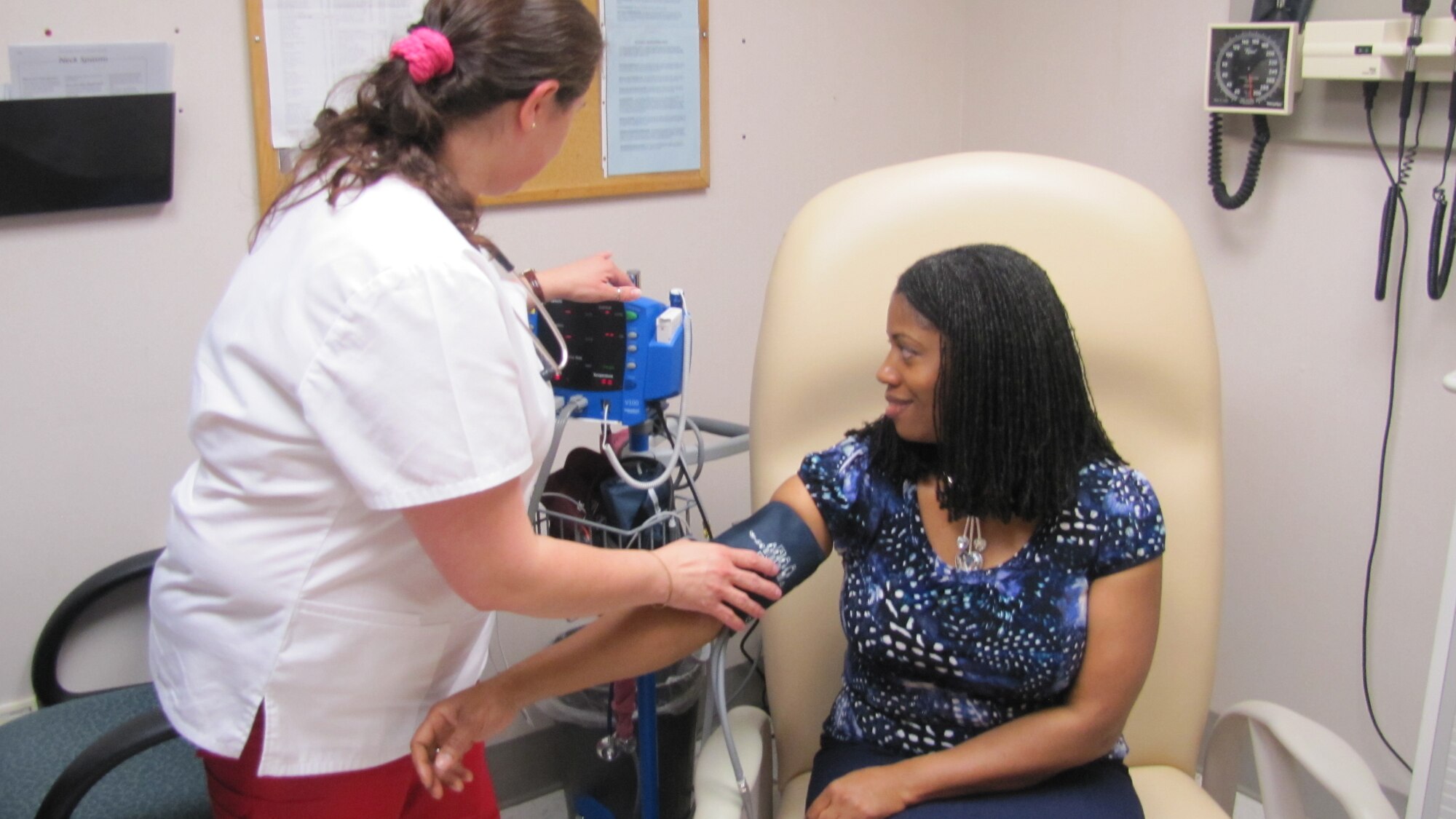 Samara Walker, McDonald Army Health Center’s head nurse of the Allergy, Immunizations and Dermatology Clinic, simulates a patient having her vital signs checked at the Ft. Eustis Clinic, Va., April 25. Nurses are trained to properly check and monitor patient vitals. (U.S. Army courtesy photo)   