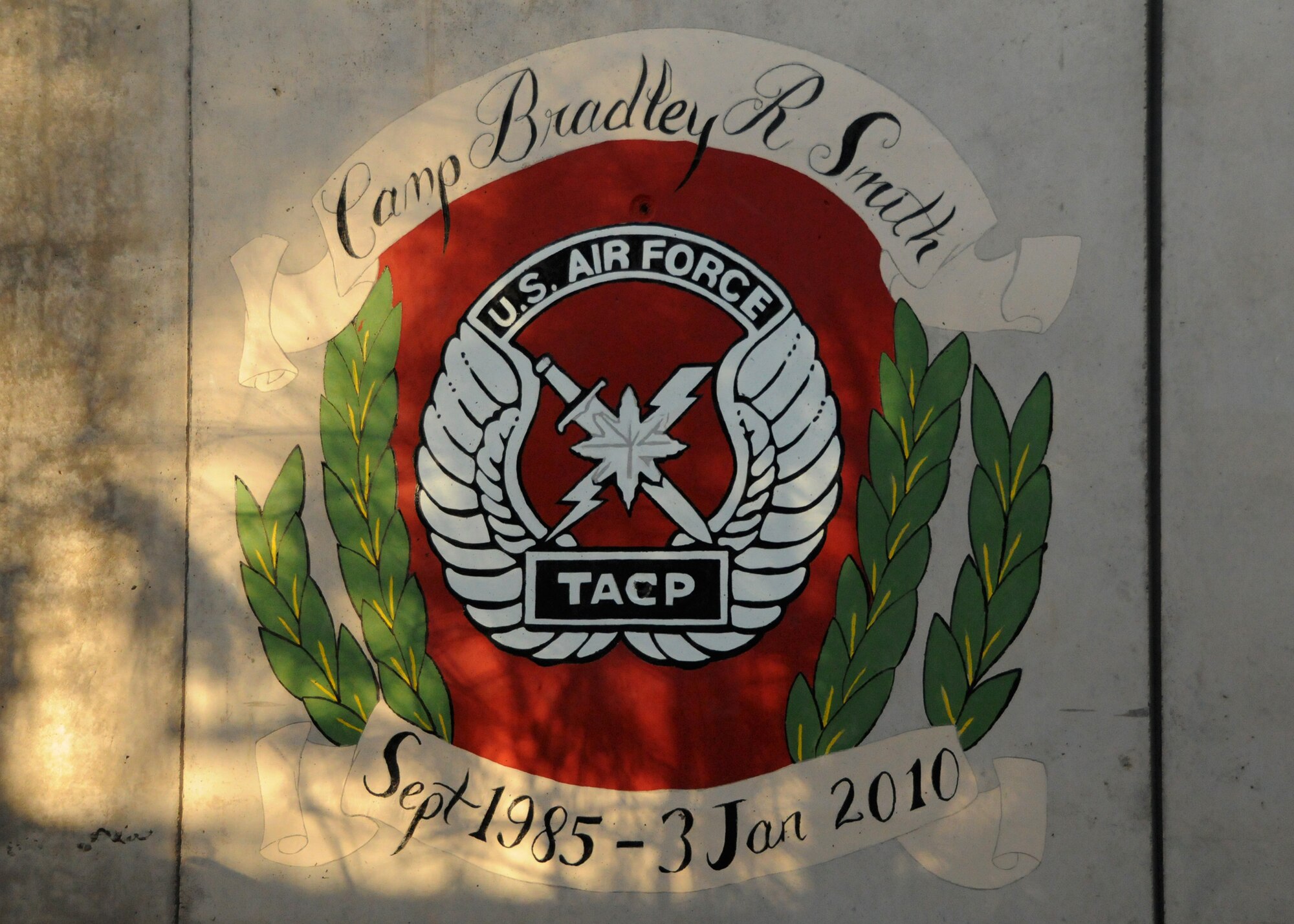 Photo of a memorial freshly painted onto a barrier next to the Morale, Welfare, and Recreation building at the newly dedicated Camp Bradley Smith here at Kandahar Airfield, Afghanistan, April 22, 2012. Camp Bradley Smith was named in honor of Senior Airman Bradley Smith, a Joint Terminal Attack Controller, who gave his life on the battlefield, January 3, 2010, recovering fallen and wounded service members while under fire. The Camp currently has more than 350 residents, but soon, once building renovations are complete the camp will house the more than 2,000 Airmen. 